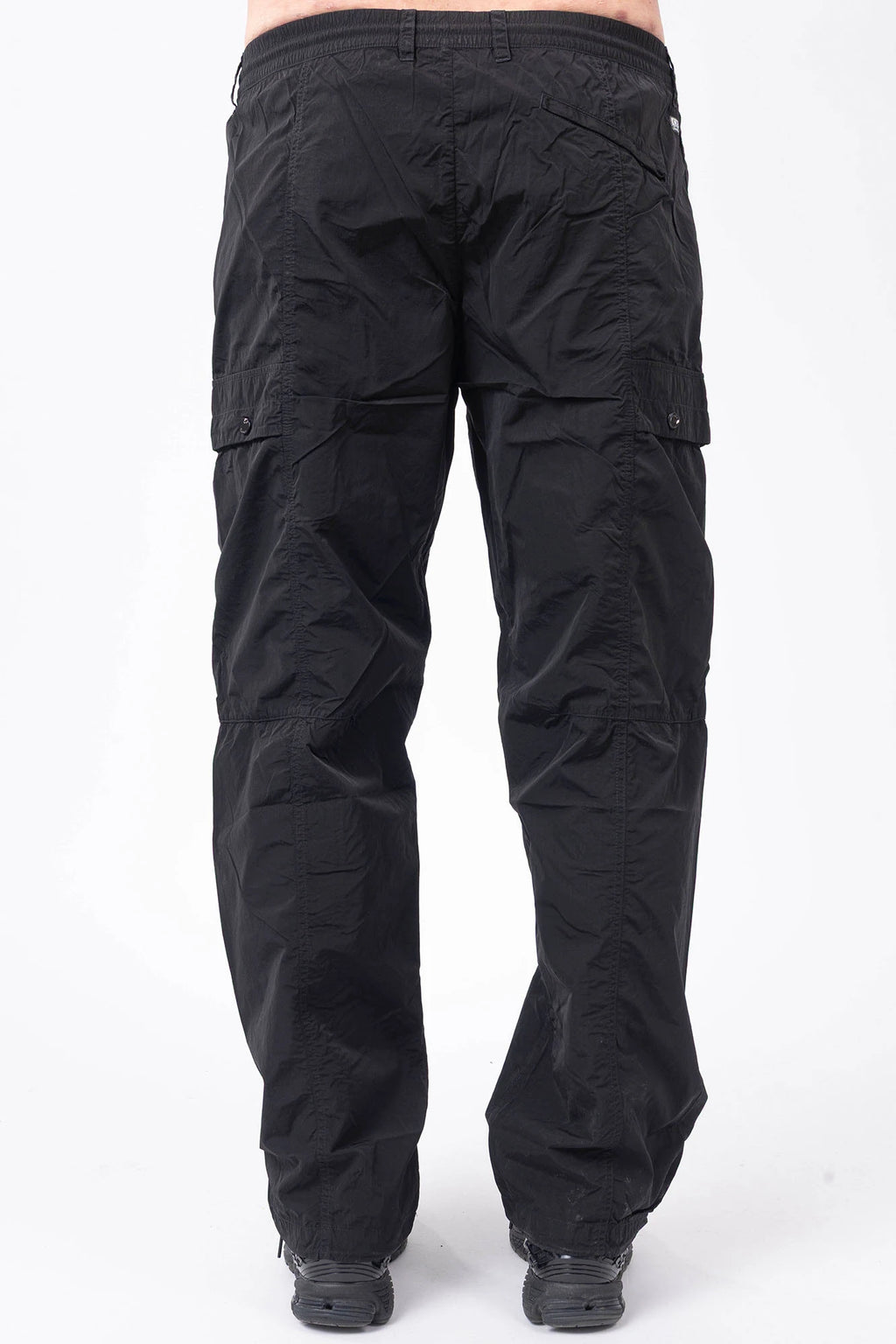 C.P. Company, Mens Pants, Black 999, Chrome-R Polyamide Nylon Trousers, Cargo Pockets, Side Pockets, Signature Lens, Lens Detail, Loose Fit, Straight Leg, Belt Loops, Zip-Fly, Button Closure, Back Pockets, British Saylor, Chester Perry, Massimo Osti, Back Portrait. 