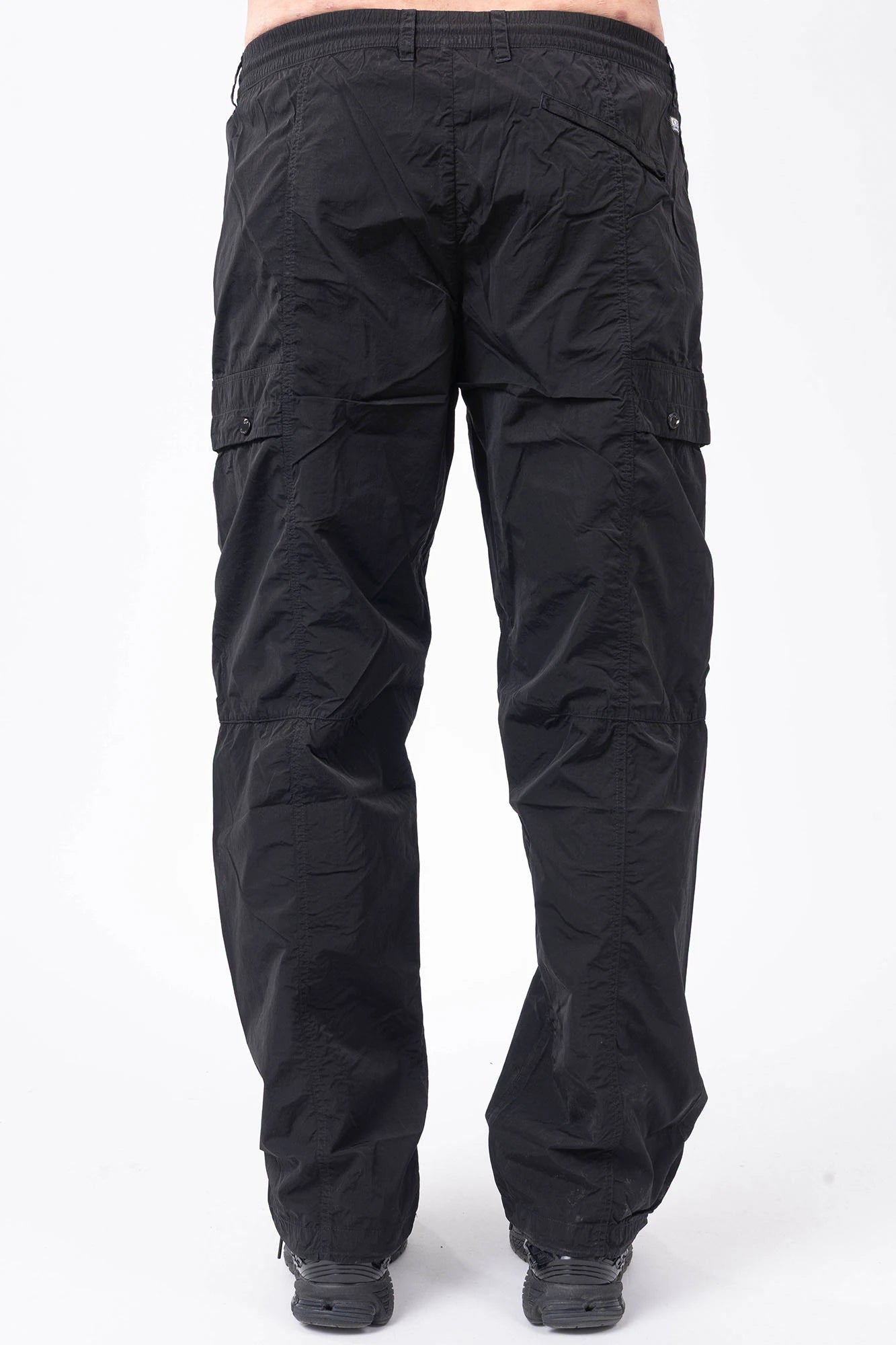 C.P. Company, Mens Pants, Black 999, Chrome-R Polyamide Nylon Trousers, Cargo Pockets, Side Pockets, Signature Lens, Lens Detail, Loose Fit, Straight Leg, Belt Loops, Zip-Fly, Button Closure, Back Pockets, British Saylor, Chester Perry, Massimo Osti, Back Portrait. 