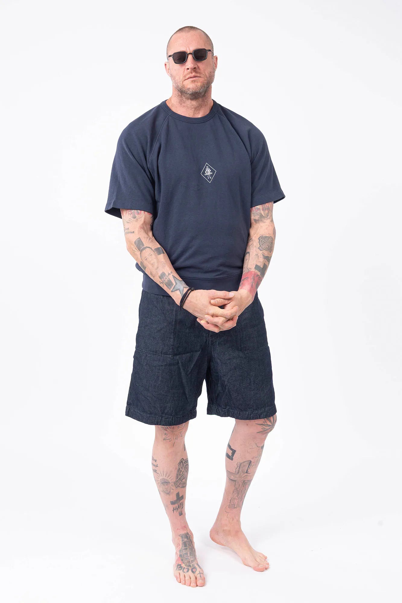 C.P. Company, Mens T-Shirt, Midnight Blue 889, Chest Printed Logo, British Saylor, White Print, Shor Sleeves, Ribbed Hem and Neck, 100% Organic Cotton, Massimo Osti, Chester Perry, Full Body Front View Rigards Sunglasses. 