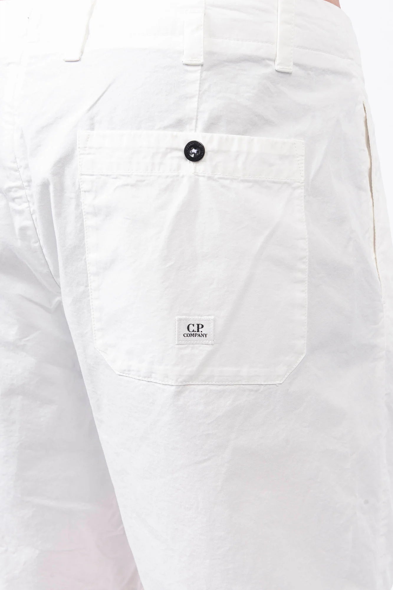 C.P. Company, Mens Shorts, Gauze White 103, Side and Back Pockets, Belt Loops, Button Closure, Breathable, Garment Dyed, Worn-in Look, Gabardine Cotton, Cotton-Polyester Lining, Back Pocket Close-up View. 