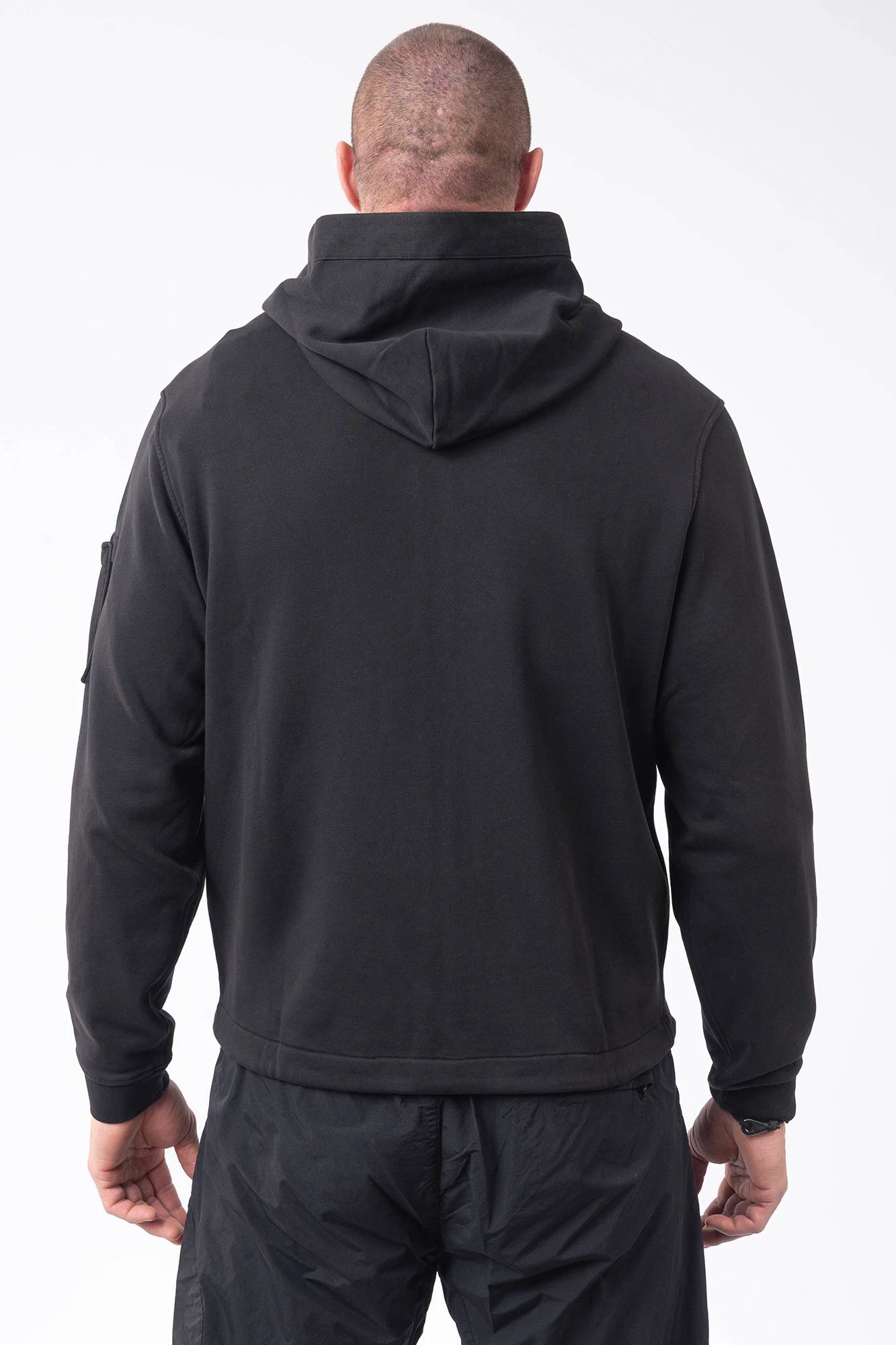 C.P. Company, Mens Sweatshirt, Black 999, Full-Zip, Lens Sleeve Pocket, Hooded, Side Pockets, Ribbed and Cuffs, Cord Adjustable Hem, Snap Closure Sleeve Pocket, Signature C.P. Company Lens Detail, Chester Perry, British Saylor, Massimo Osti, Garment Dyeing Techniques, Back Portrait. 