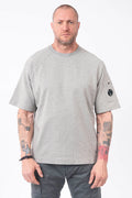 C.P. Company, Mens T-Shirt, Greystone Melange M94, Grey, Gray, Raglan Sleeves, Lens Sleeve Pocket, C.P. Company Signature Lens Detail, Cotton Fleece, Ribbed Hems and Neck, Tattoos, Massimo Osti, Chester Perry, C.P. Company Grey Cotton Cargo Pants, Front Portrait. 