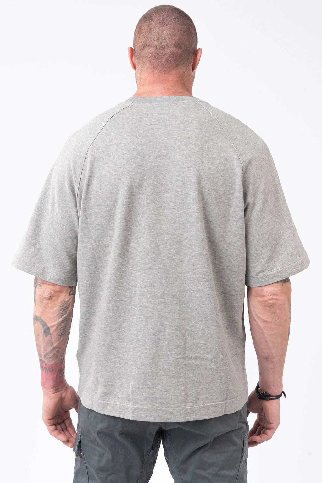 C.P. Company, Mens T-Shirt, Greystone Melange M94, Grey, Gray, Raglan Sleeves, Lens Sleeve Pocket, C.P. Company Signature Lens Detail, Cotton Fleece, Ribbed Hems and Neck, Tattoos, Massimo Osti, Chester Perry, C.P. Company Grey Cotton Cargo Pants, Back Portrait. 
