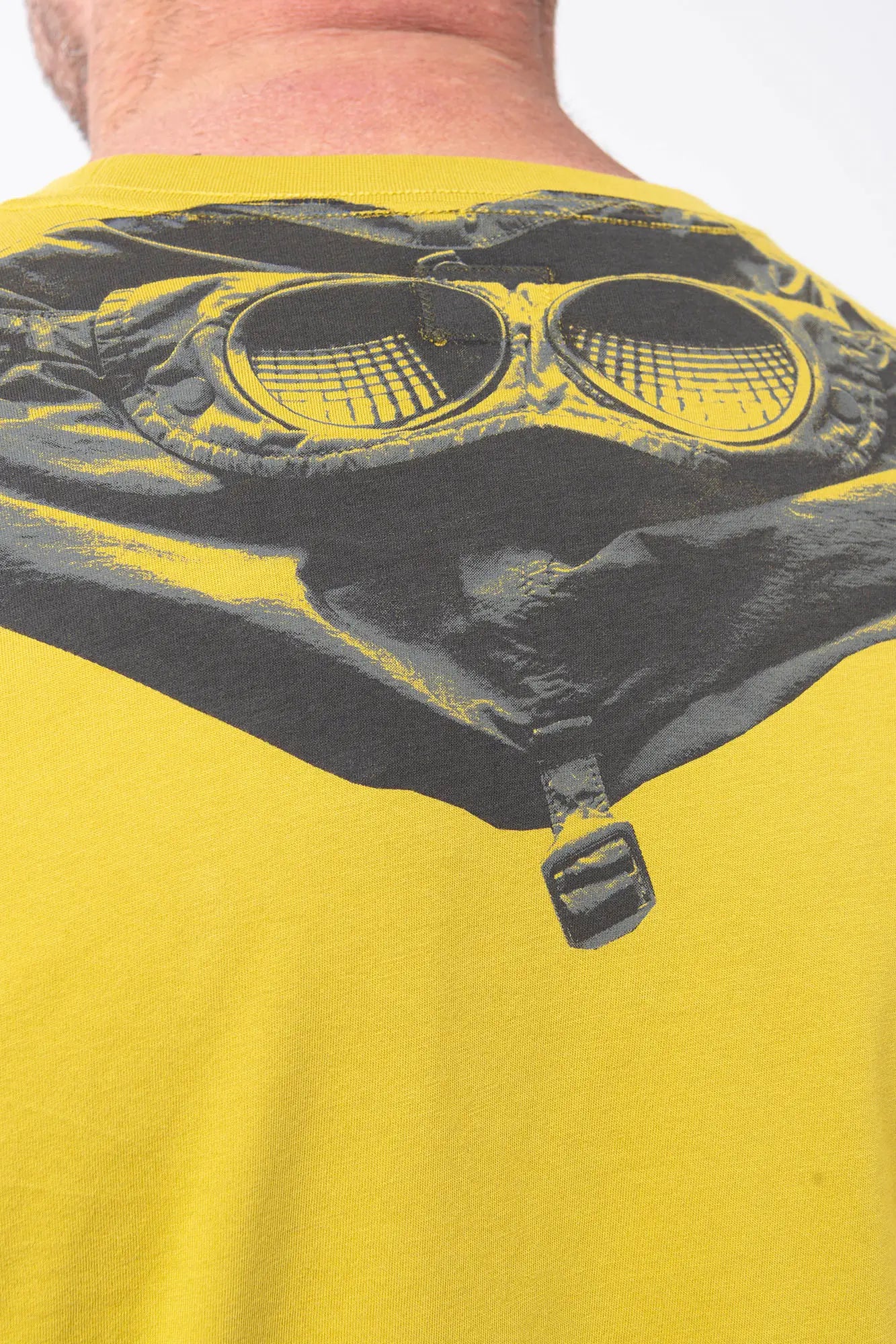 CP Company, Mens T-Shirt, Antique Moss, Yellow, Garment Dyed, Chest Logo Print, Back 'Goggles' Print, Short Sleeves, 100% Cotton, Ribbed Hems and Neck, Tattoos, Rigards Sunglasses, White CP Company Cotton Shorts, Back Print Close-up. 