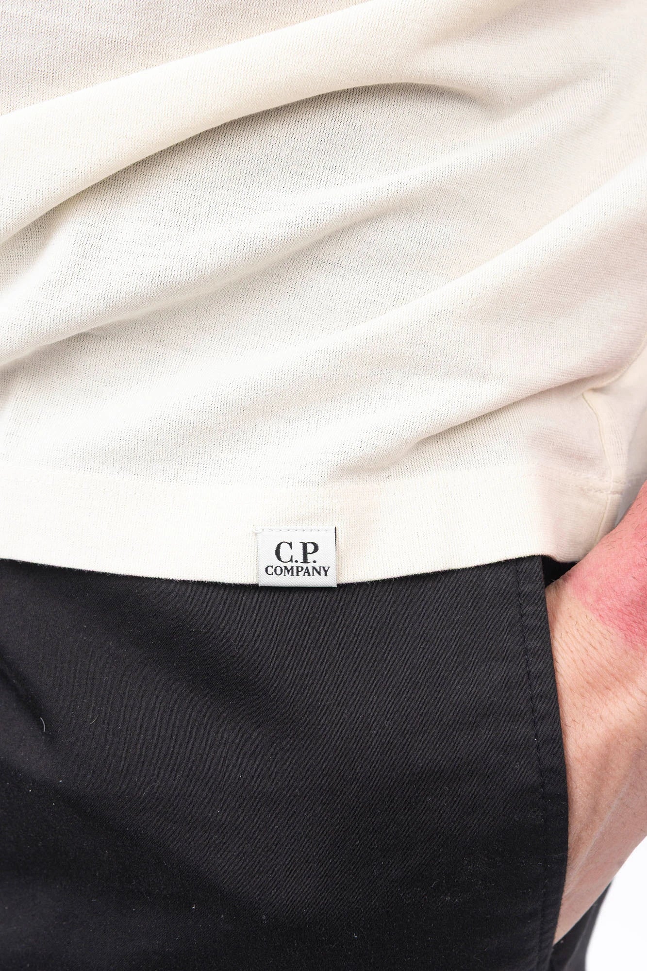 C.P. Company, Mens T-Shirt, White, Frozen Dew 114, Organic Cotton, One Color, Crew Neck, Round Neck, 100% Cotton, Ribbed Neckline and Sleeve Ends, Chester Perry, Massimo Osti, Made in Italy, Hem Logo Close-up. 
