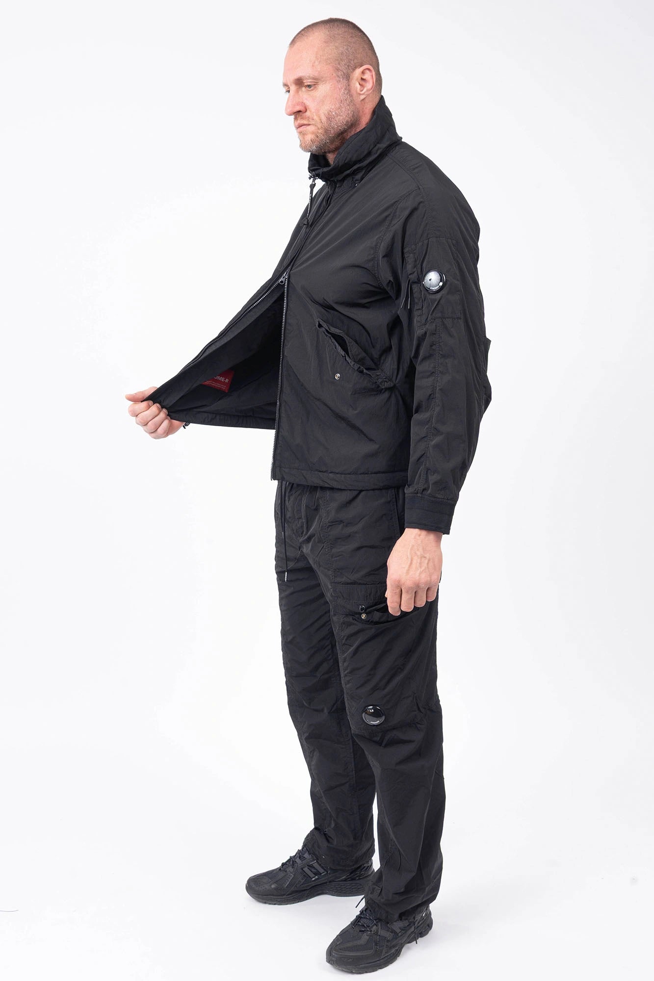 C.P. Company, Mens Jacket, Black 999, Concealed Hood, Chrome-R, Polyamide, Full-Zip, Side Flap Pockets, Sleeve Lens Pocket, Centre Zip Closure, Long Sleeves, Ribbed Elastic Cuffs, Branded Zip Puller, YKK Zippers, Two-Way Zipper, Full Body Front 3/4 View. 