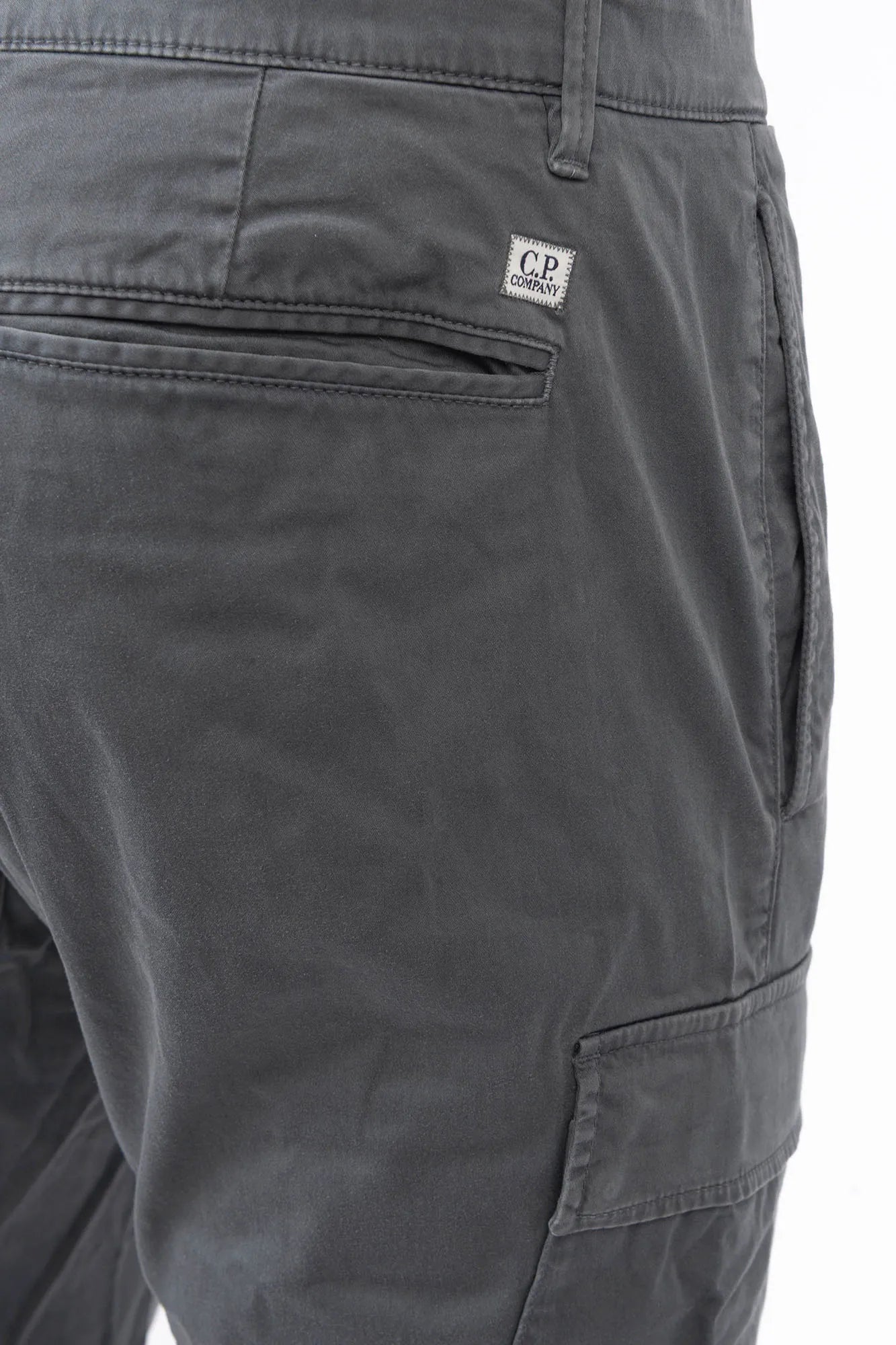 C.P. Company, Mens Pants, Gunmetal 921, Grey, Gray, Cargo Pockets, Stretch Cotton Sateen, Snap Closure Cargo Pockets, Side Pockets, Back Pockets, Belt Loops, Button Closure, Zip-Fly, Massimo Osti, Chester Perry, British Saylor, Signature Lens, Lens Pocket, Back Pocket Close-up View. 
