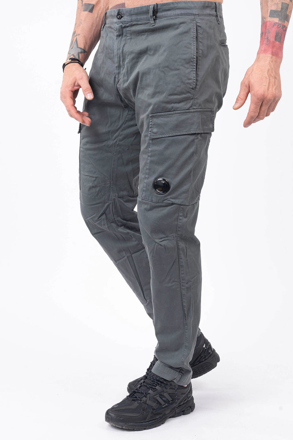 C.P. Company, Mens Pants, Gunmetal 921, Grey, Gray, Cargo Pockets, Stretch Cotton Sateen, Snap Closure Cargo Pockets, Side Pockets, Back Pockets, Belt Loops, Button Closure, Zip-Fly, Massimo Osti, Chester Perry, British Saylor, Signature Lens, Lens Pocket, Front 3/4 View Step Forward. 
