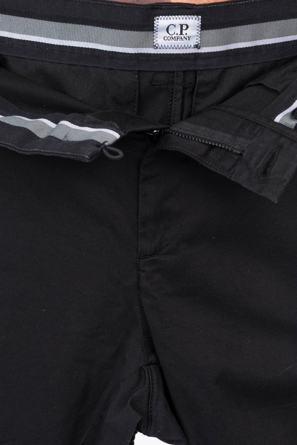 C.P. Company, Mens Cargo Pants, Black 999, Stretch Cotton Satin, Elastic, Cargo Pockets, Side Pockets, Belt Loops, Button Closure, Zip-Fly, Lens Pocket Detail, Massimo Osti, Chester Perry, British Saylor, Logo Patch Close-up. 