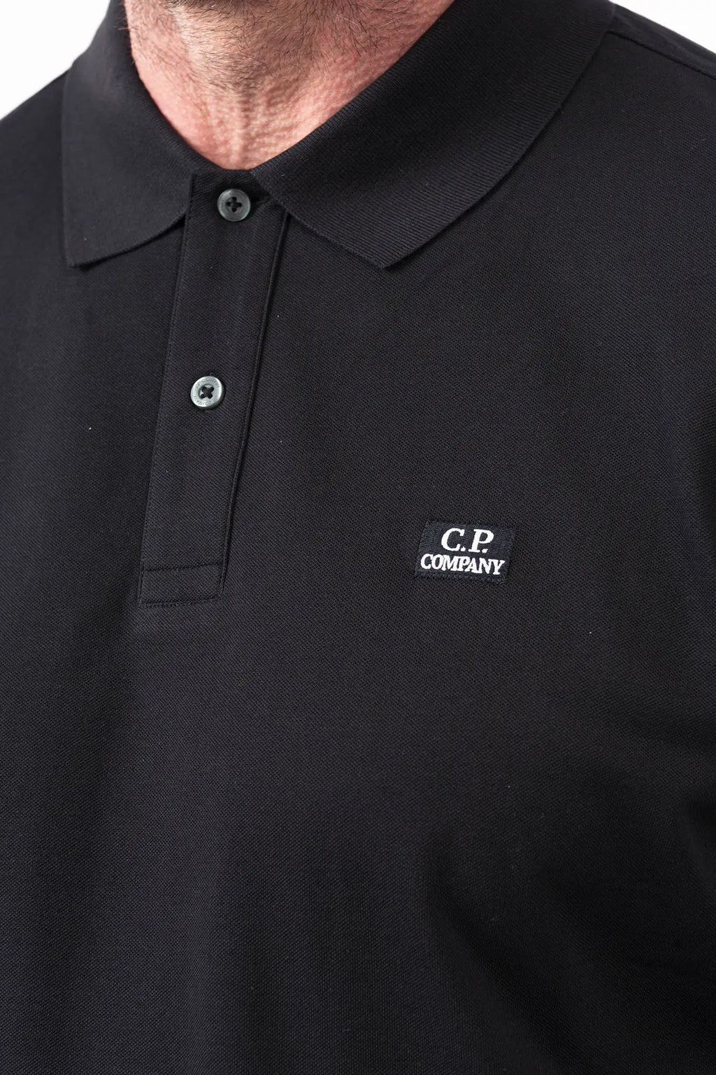 C.P. Company, Mens Polo Shirt, Black 999, Collar, Button Closure, Short Sleeves, Ribbed Hems, Stretch Cotton Pique, Chest Embroidery, Chester Perry, Massimo Osti, British Saylor, Rigards Sunglasses, Chest Embroidery Close-up. 
