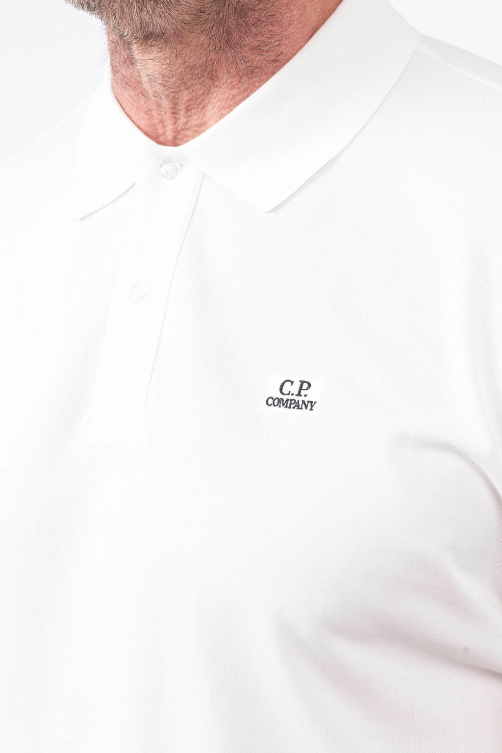 C.P. Company, Mens Polo Shirt, Gauze White 103, Collar, Button Closure, Short Sleeves, Ribbed Hems, Stretch Cotton Pique, Chest Embroidery, Chester Perry, Massimo Osti, British Saylor, Rigards Sunglasses, Chest Embroidery Close-up. 