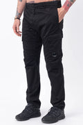 C.P. Company, Mens Pants, Black 999, Side Pockets, Cargo Flap Pockets, Lens Pocket Detail, Belt Loops, Button Closure, Zip-fly, Back Pockets, Stretch Cotton Sateen, Massimo Osti, Chester Perry, British Saylor, Front 3/4 View Hand in Pocket. 