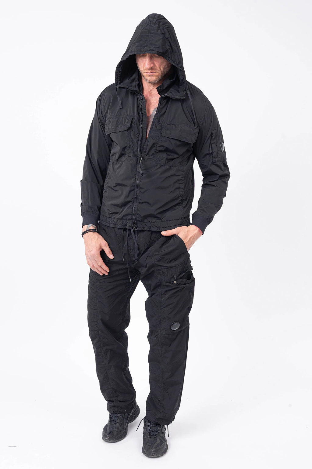 C.P. Company, Mens Jacket, Black 999, Stretch Nylon, Shell-R, Nycra-R, Hooded, Water-Resistant, Wind-Resistant, Windproof, Waterproof, Full-Zip, Centre Zip Closure, Bellow Pockets, Side Pockets, Sleeve Pocket, Massimo Osti, Chester Perry, Full Body Front View. 