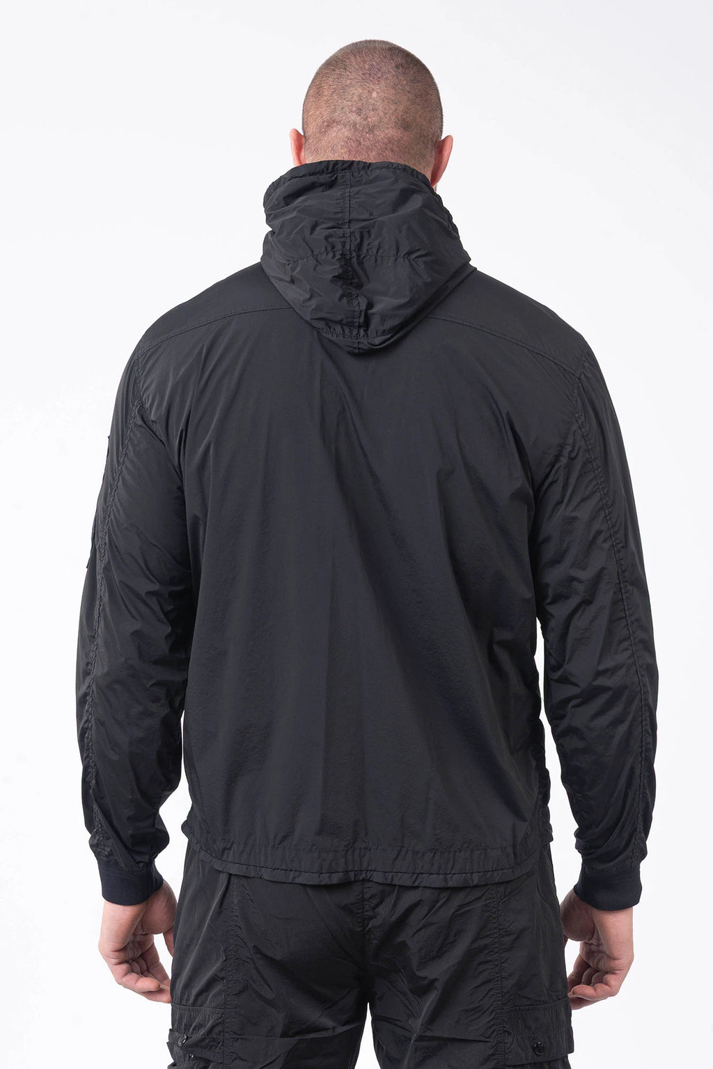 C.P. Company, Mens Jacket, Black 999, Stretch Nylon, Shell-R, Nycra-R, Hooded, Water-Resistant, Wind-Resistant, Windproof, Waterproof, Full-Zip, Centre Zip Closure, Bellow Pockets, Side Pockets, Sleeve Pocket, Massimo Osti, Chester Perry, Back Portrait. 