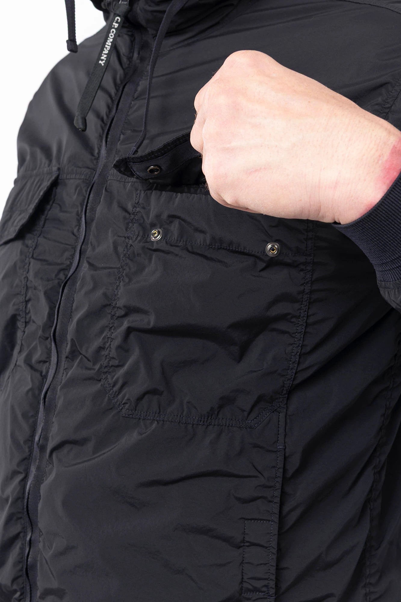 C.P. Company, Mens Jacket, Black 999, Stretch Nylon, Shell-R, Nycra-R, Hooded, Water-Resistant, Wind-Resistant, Windproof, Waterproof, Full-Zip, Centre Zip Closure, Bellow Pockets, Side Pockets, Sleeve Pocket, Massimo Osti, Chester Perry, Chest Pocket Close-up. 