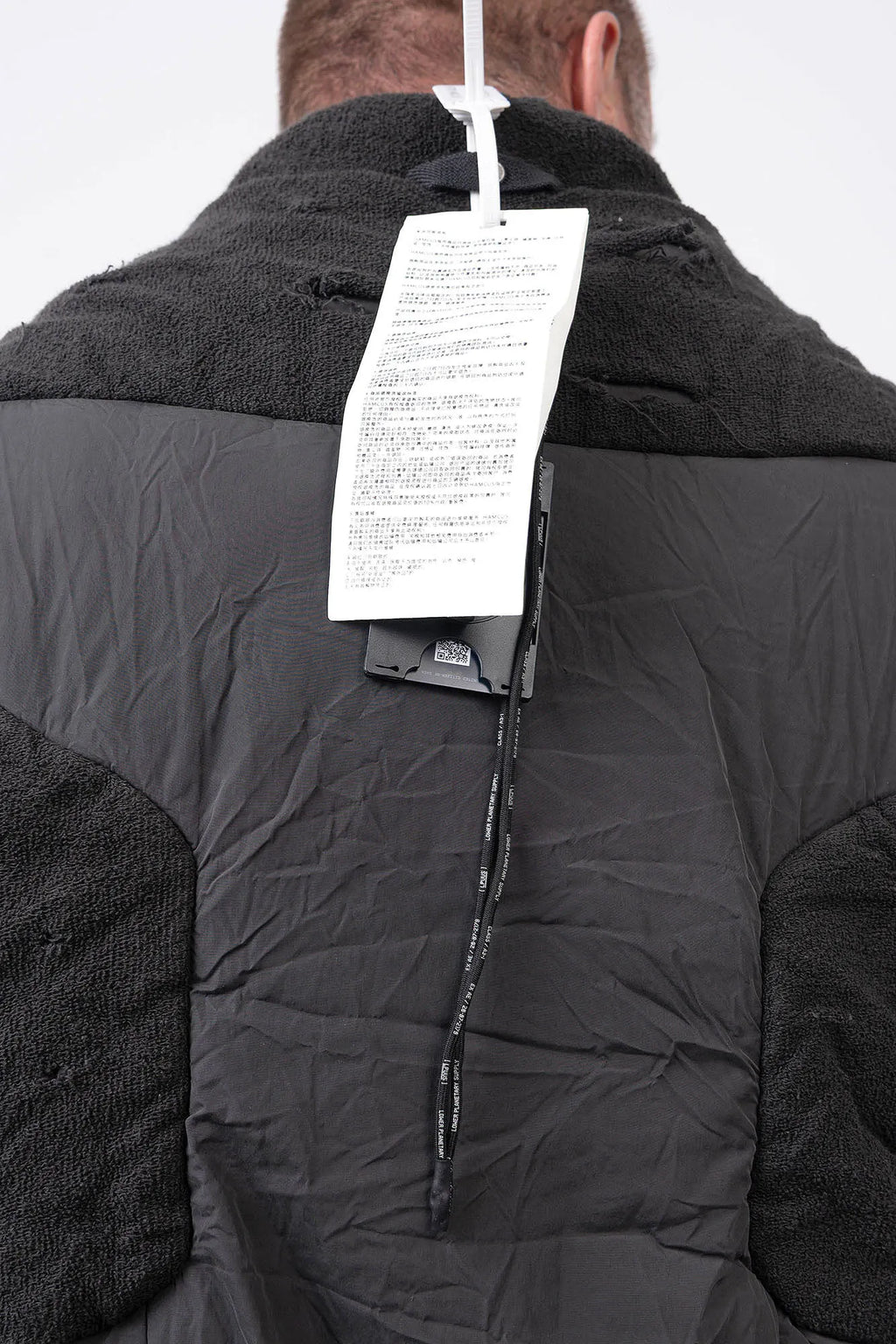 Hamcus, Mens Vest, Matte Black, Multi-Fabric Blend, Panel Construction, Patchwork Design, Heavy-Duty Vislon Zipper, Worn Appearance, Functional Pockets, Hidden Pockets, Breathable, Back LP World Print, Back Portrait Badge Close-up. 