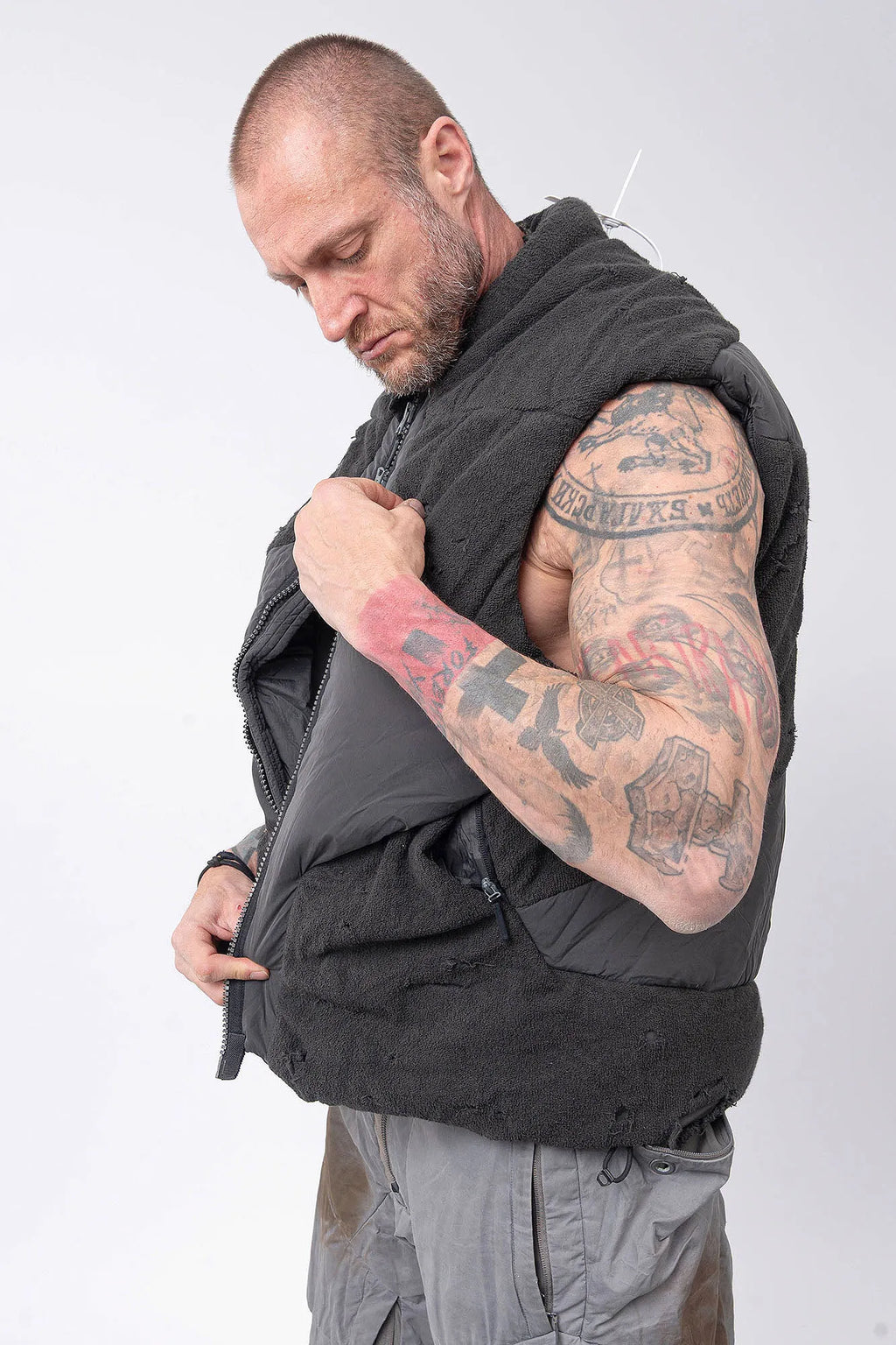 Hamcus, Mens Vest, Matte Black, Multi-Fabric Blend, Panel Construction, Patchwork Design, Heavy-Duty Vislon Zipper, Worn Appearance, Functional Pockets, Hidden Pockets, Breathable, Back LP World Print, Full-Zip Showcase Side Portrait. 