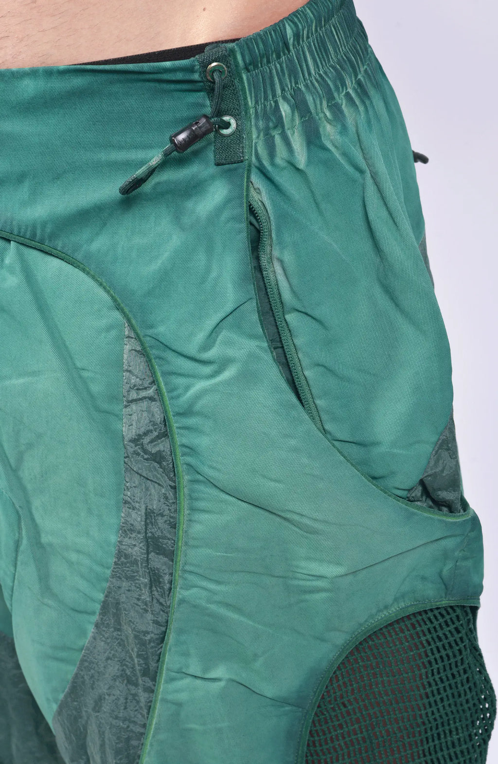 Hamcus, Mens Pants, Green, Garment Dyed, Multi Fabric Panel Construction, Elasticated Waistband, Cord Adjustable, Buckles, Side Mesh Panels, Elasticated Cuffs, Adjustable Cuffs, Long Sleeves, Ventilated, Side Pockets, Zippers, Zip-Fly, Zip Pockets Close-up. 