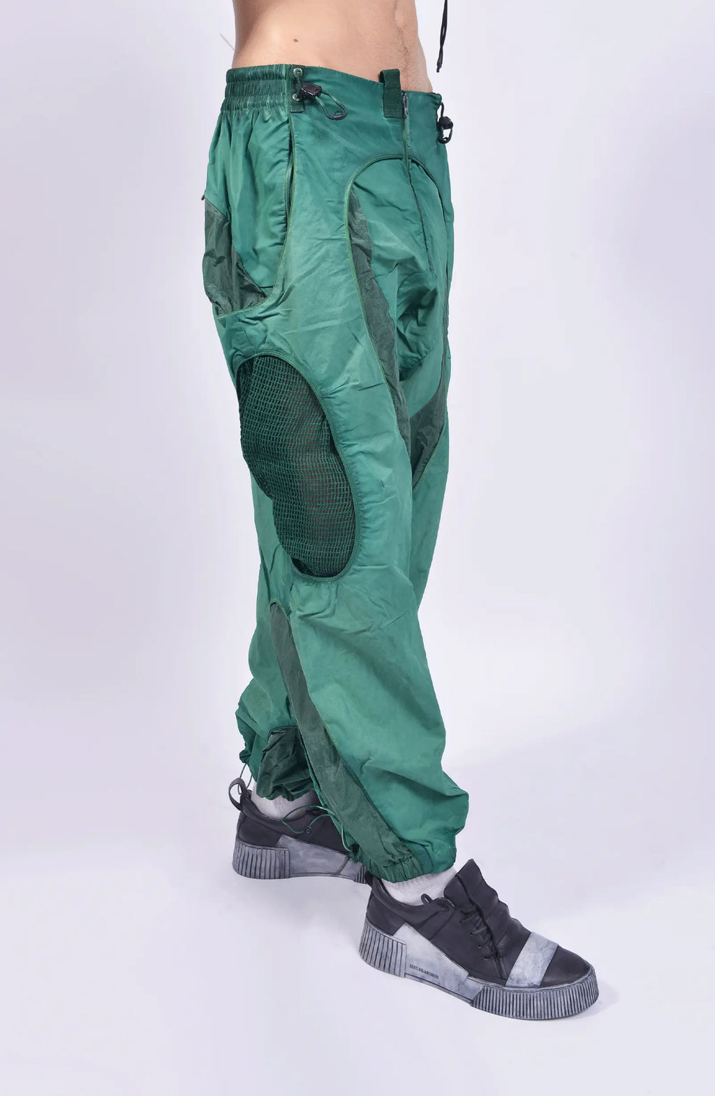 Hamcus, Mens Pants, Green, Garment Dyed, Multi Fabric Panel Construction, Elasticated Waistband, Cord Adjustable, Buckles, Side Mesh Panels, Elasticated Cuffs, Adjustable Cuffs, Long Sleeves, Ventilated, Side Pockets, Zippers, Zip-Fly, Front 3/4 Step Forward View. 