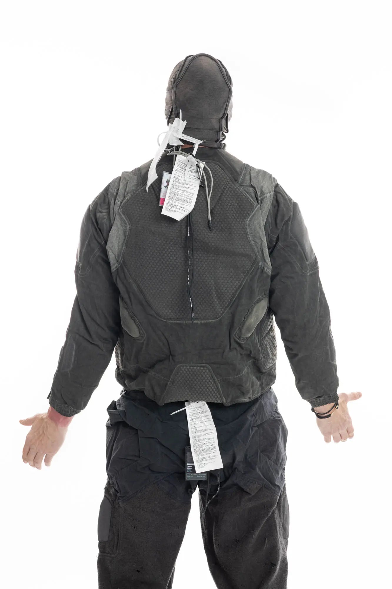 Hamcus, Mens Jacket, Dark Grey, Grey, Multicolor, Garment-Dyed, Detachable Sleeves, Adjustable Cuffs, Skimask, Module Construction, Wearable Sponge Panels, Side Zip Pockets, Multiple Zippers, Multiple Pockets, Back View Hands to the Side. 