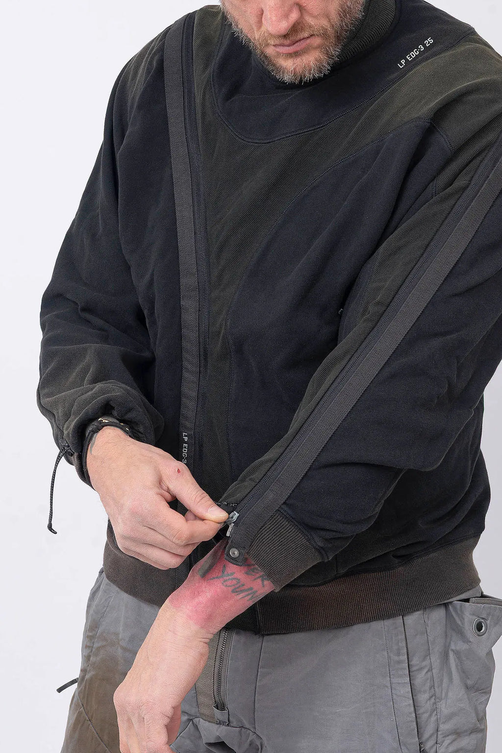Hamcus, Mens Pullover, Black, Olive Green, Dual Long Zippers, Hybrid Garment, Convertible Garment, Long Sleeves, Adjustable Drawcord Cuffs, Ribbed Cuffs and Hem, Ventilation Design, Breathable, Modular, Multi-Functional, Front Portrait. 