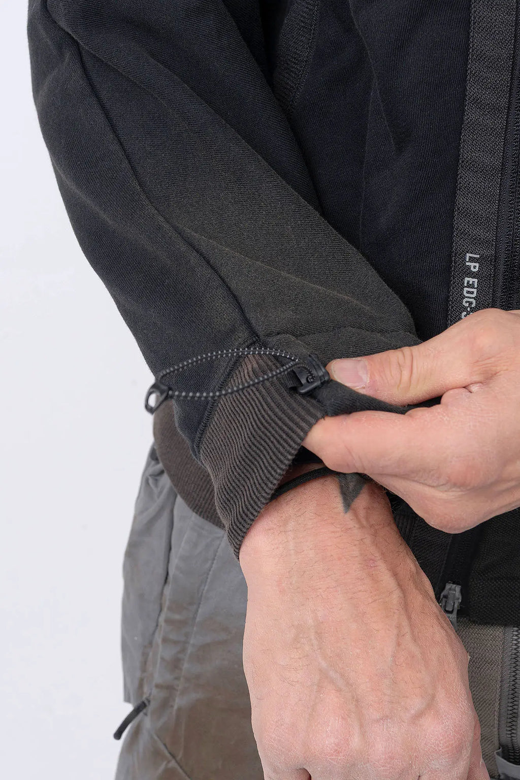 Hamcus, Mens Pullover, Black, Olive Green, Dual Long Zippers, Hybrid Garment, Convertible Garment, Long Sleeves, Adjustable Drawcord Cuffs, Ribbed Cuffs and Hem, Ventilation Design, Breathable, Modular, Multi-Functional, Sleeve Cuff Adjustment Showcase. 