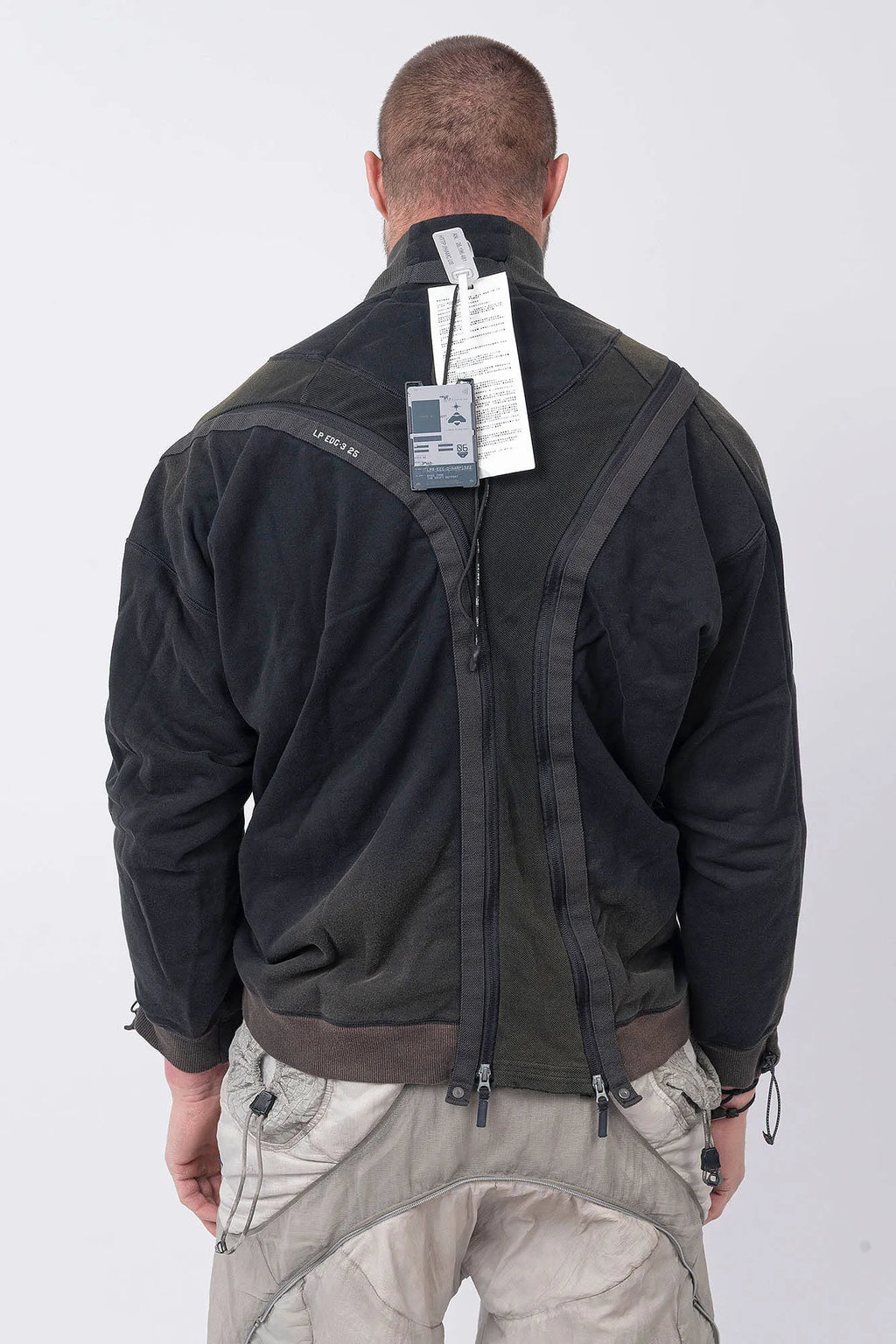 Hamcus, Mens Pullover, Black, Olive Green, Dual Long Zippers, Hybrid Garment, Convertible Garment, Long Sleeves, Adjustable Drawcord Cuffs, Ribbed Cuffs and Hem, Ventilation Design, Breathable, Modular, Multi-Functional, Back Portrait. 