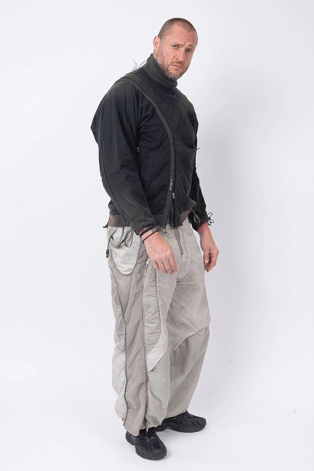 Hamcus, Mens Pullover, Black, Olive Green, Dual Long Zippers, Hybrid Garment, Convertible Garment, Long Sleeves, Adjustable Drawcord Cuffs, Ribbed Cuffs and Hem, Ventilation Design, Breathable, Modular, Multi-Functional, Full Body Front 3/4 View. 