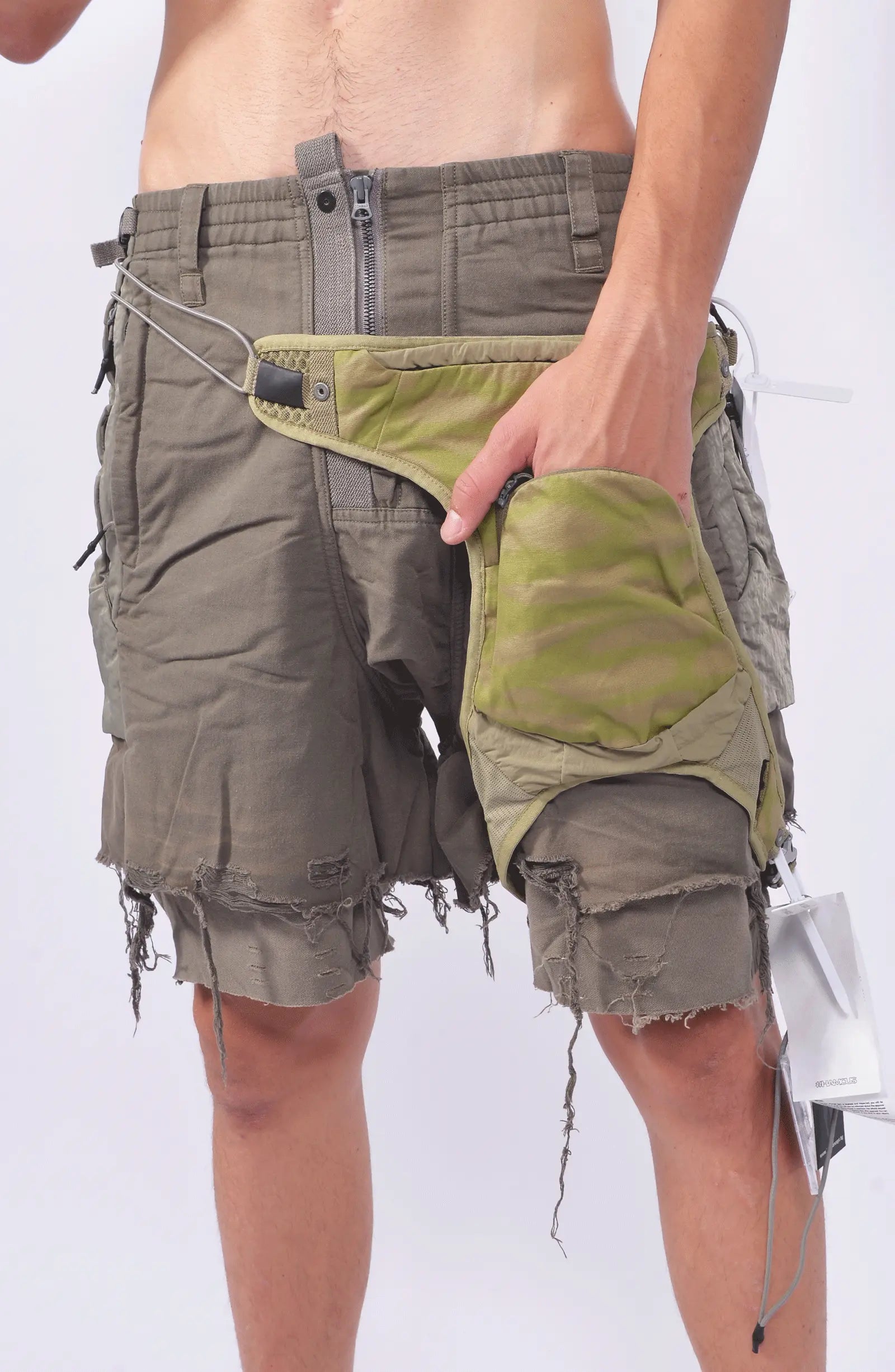 Hamcus, Mens Gun Bag, Yellow, Green, Washed, Camo, Waterproof, Unisex, Elastic, Leg Straps, Pockets, Zippers, Mesh, Elastic, Polyester, Buckle, Adjustable, On-Model Hand in Pocket View. 