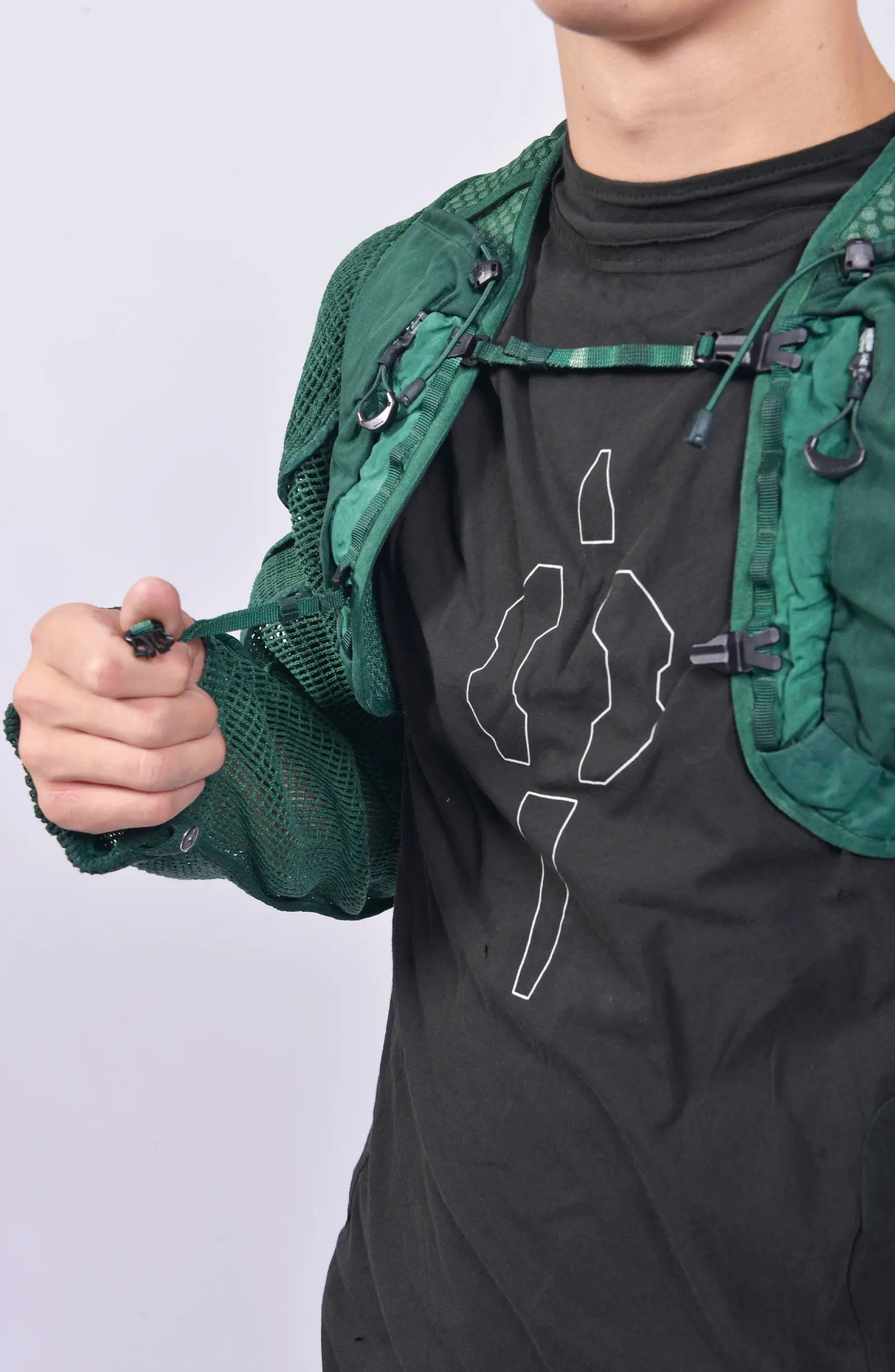 Hamcus, Mens Vest, Ultramarine Green, Mesh, Unisex, Breathable, Hooded, Long Sleeves, Detachable Sleeves, Pockets, Zippers, Zip Pockets, Buckle, Organic Cotton, Polyamide, Polyester, Elastane, Spandex, Elasticated Cuffs, Silver Tone Details, Buckle Closure Close-up. 