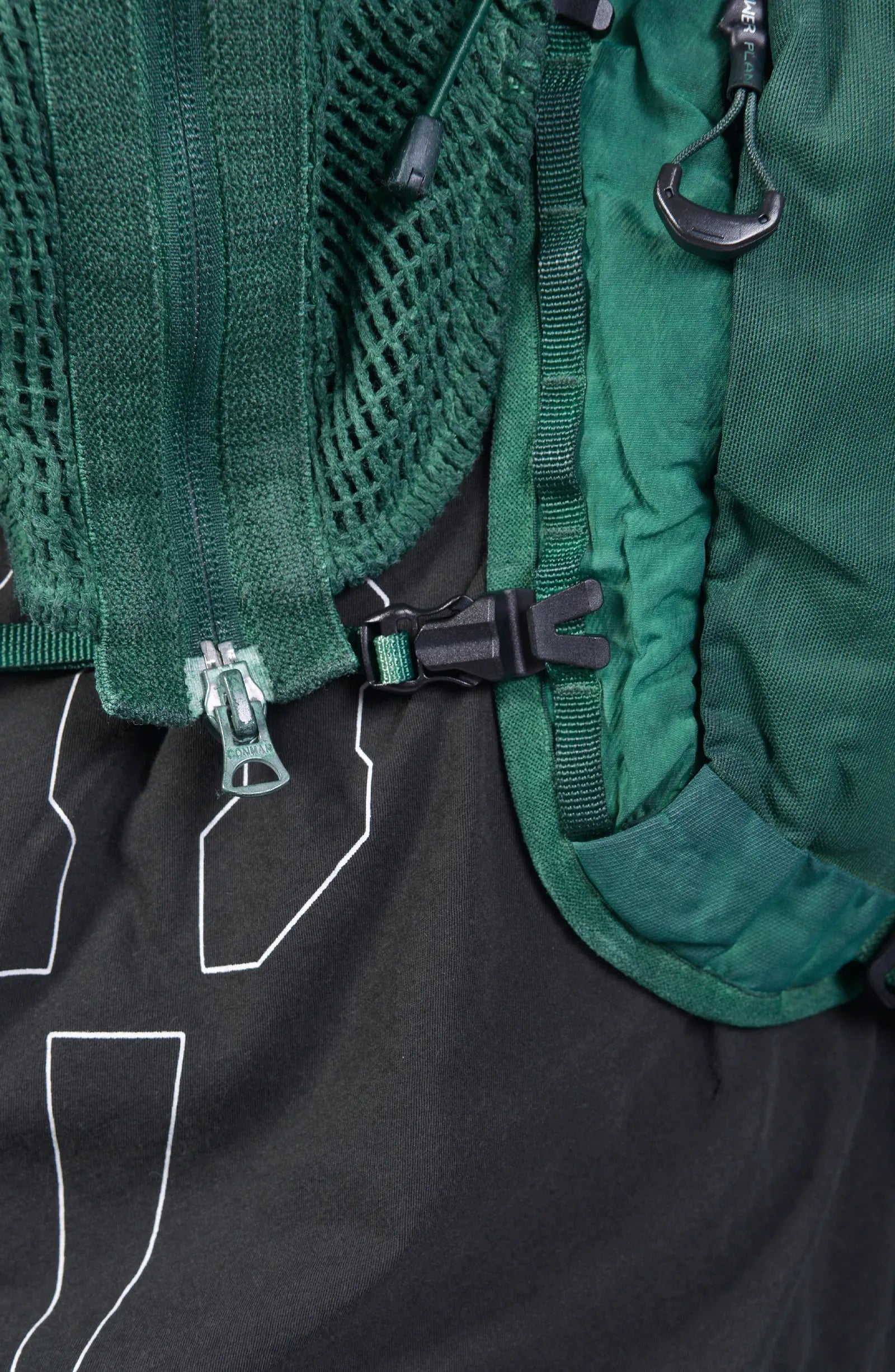 Hamcus, Mens Vest, Ultramarine Green, Mesh, Unisex, Breathable, Hooded, Long Sleeves, Detachable Sleeves, Pockets, Zippers, Zip Pockets, Buckle, Organic Cotton, Polyamide, Polyester, Elastane, Spandex, Elasticated Cuffs, Silver Tone Details, Zip and Buckle Closure Close-up. 