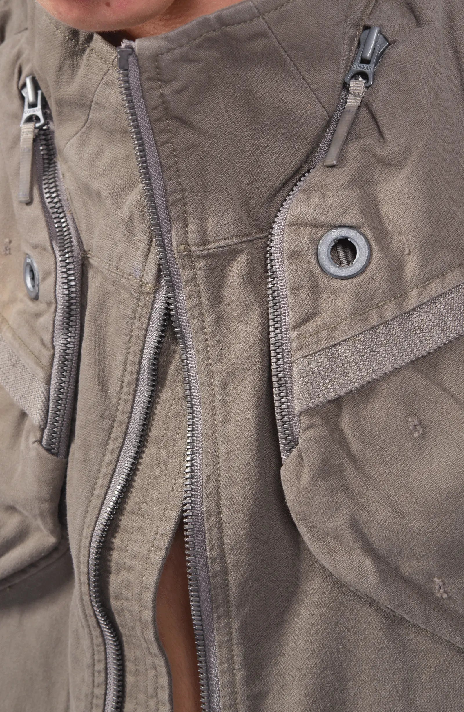 Hamcus, Mens Vest, Phantom Dark, Grey, Beige, Light Gray, Unisex, Multiple Pockets, Full-Zip, Side Zip Pockets, Zip Ventilation, Adjustable Elastic Waist, Modular Design, Panel Construction, Dyed, Silver-Tone Details, Front Zip Close-up. 