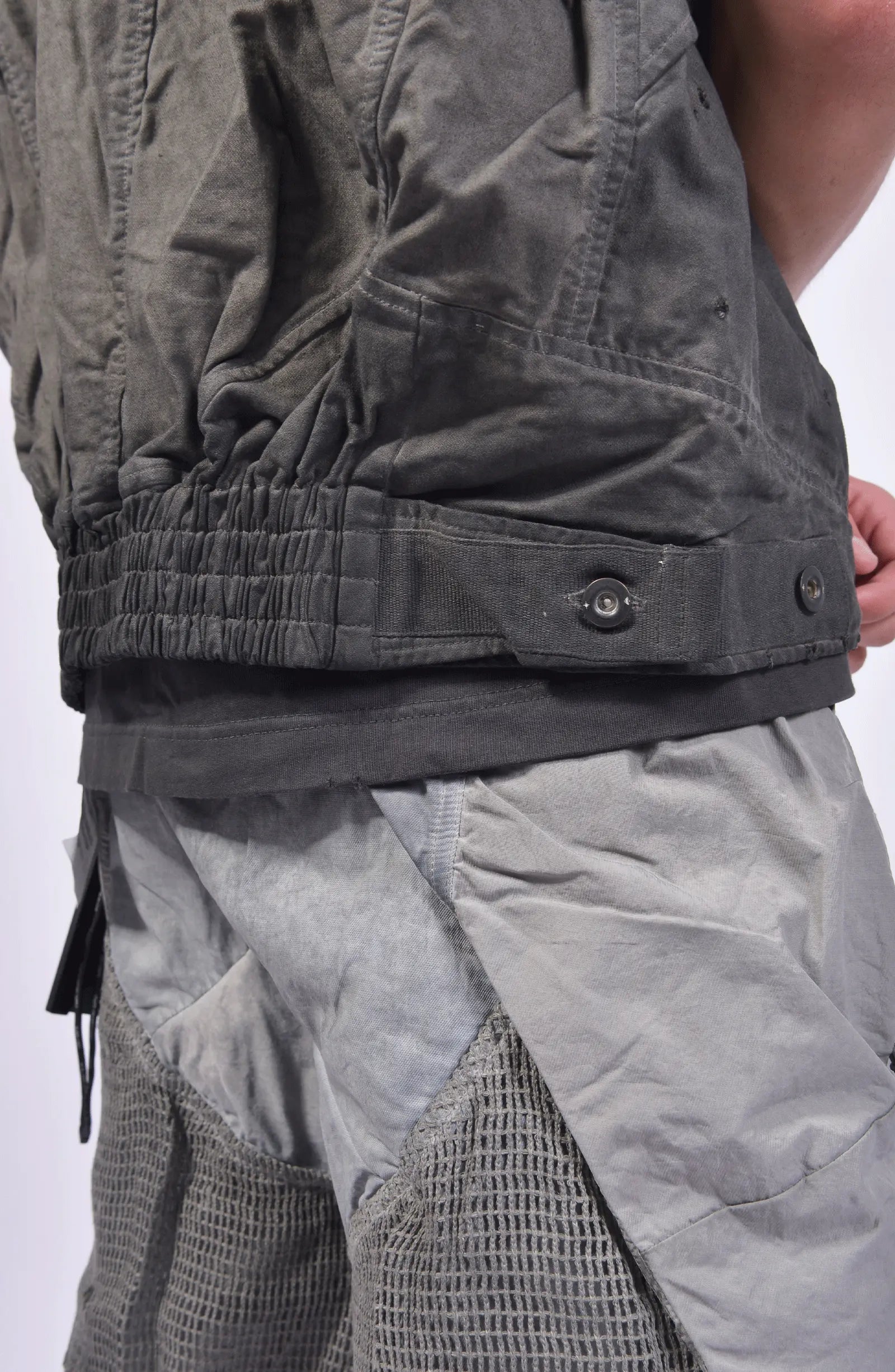 Hamcus, Mens Vest, Dark Grey, Black, Grey, Garment Dyed, 100% Cotton, Organic Cotton, Silver Tone Details, Unisex, Full-Zip, Centre Zip Closure, Zip Pockets, Front Pockets, Chest Pockets, Sleeveless, Adjustable Elasticated Hem, Elasticated Hem Back 3/4 Close-up View. 