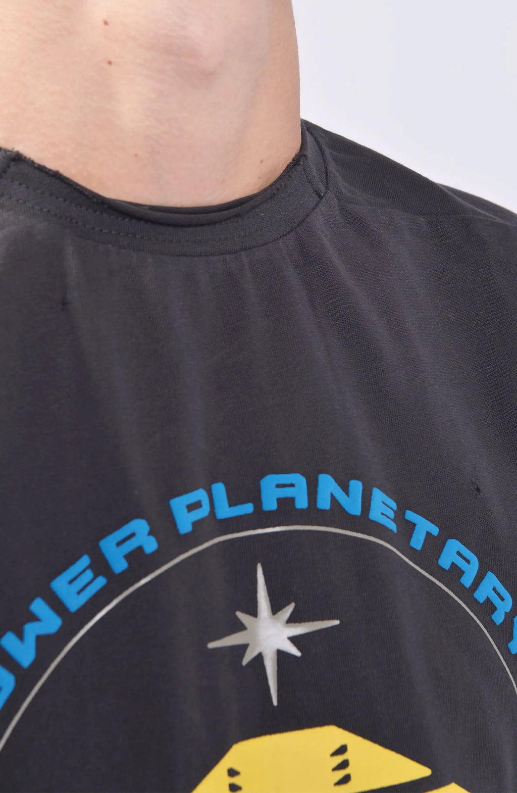 Hamcus, Mens Tank Top, Cloudy Black, Garment Dyed, No Sleeves, Dropped Shoulders, Loose Fit, Cotton, Distressed Fabric, Worn Look, LP World Print, Astro Mining Squad 325, Lower Planetary, Blue and Yellow, Neck Fit Close-up. 