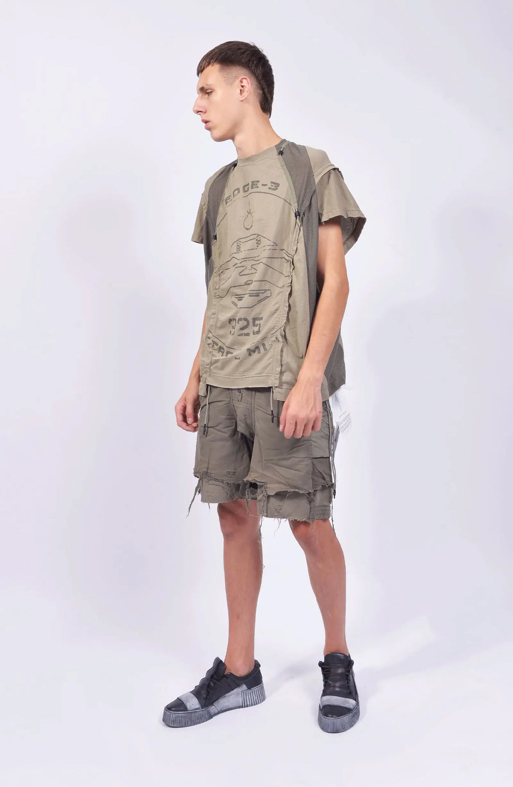 Hamcus, Mens Tanktop, Beige, Bone, Ivory, Creamy White, Off-White, Front Print, Panel Construction, Breathable Mesh, Webbing Details, Dropped Shoulders, Vintage Wash Treatment, Rope Details, Mesh Panels, Tech Top, Full Body Front View Looking Sideways. 