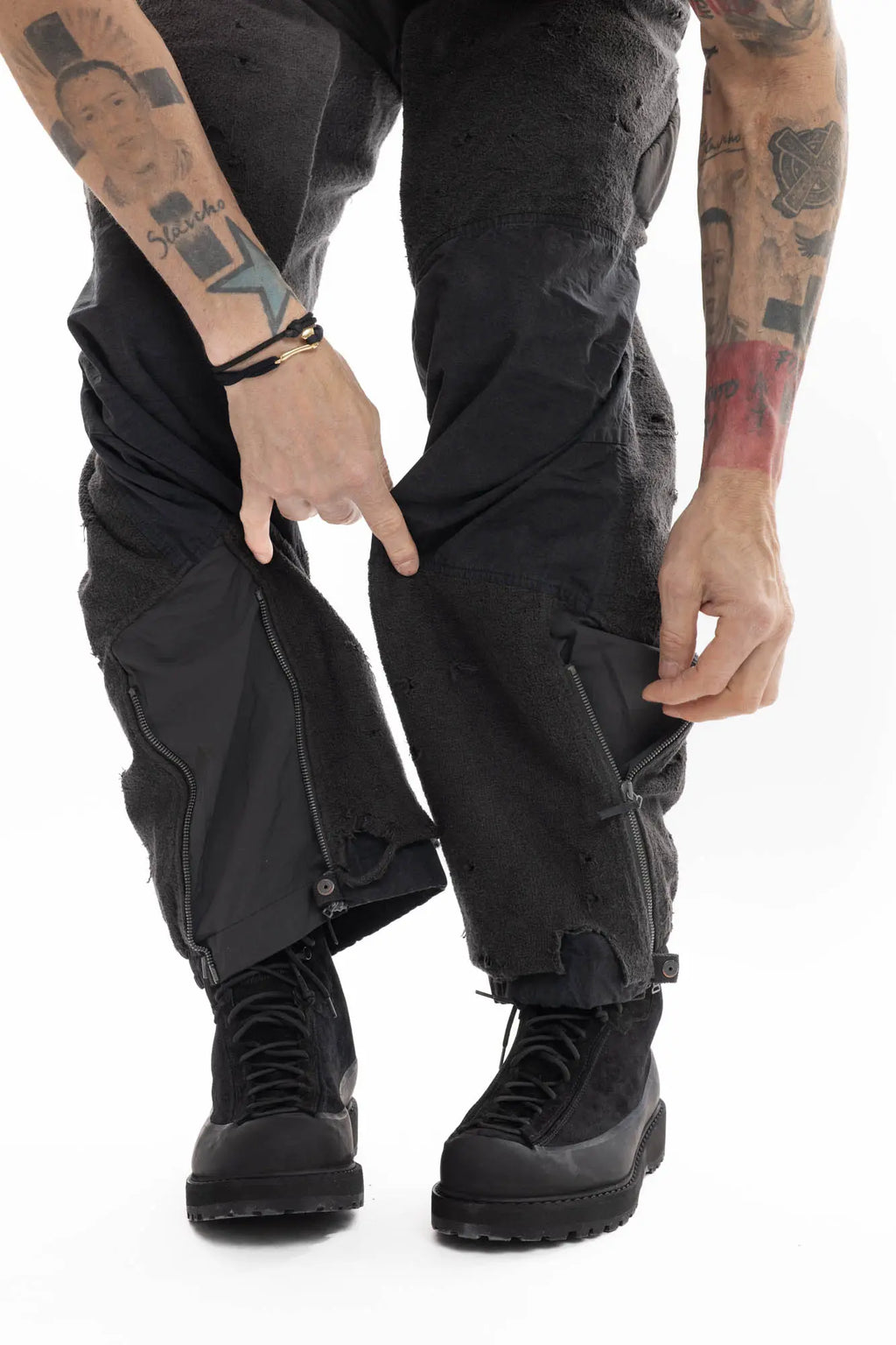Hamcus, Mens Trousers, Black, Dark Grey, Straight Leg, Adjustable Cuffs, Side Pockets, Back Pockets, Belt Loops, Zip Fly, Multi Panel Construction, Leg Zips, Torn Design, Snap Closure, Drawcord Pockets, Vislon Zippers, Close-up Leg Zipper Showcase. 