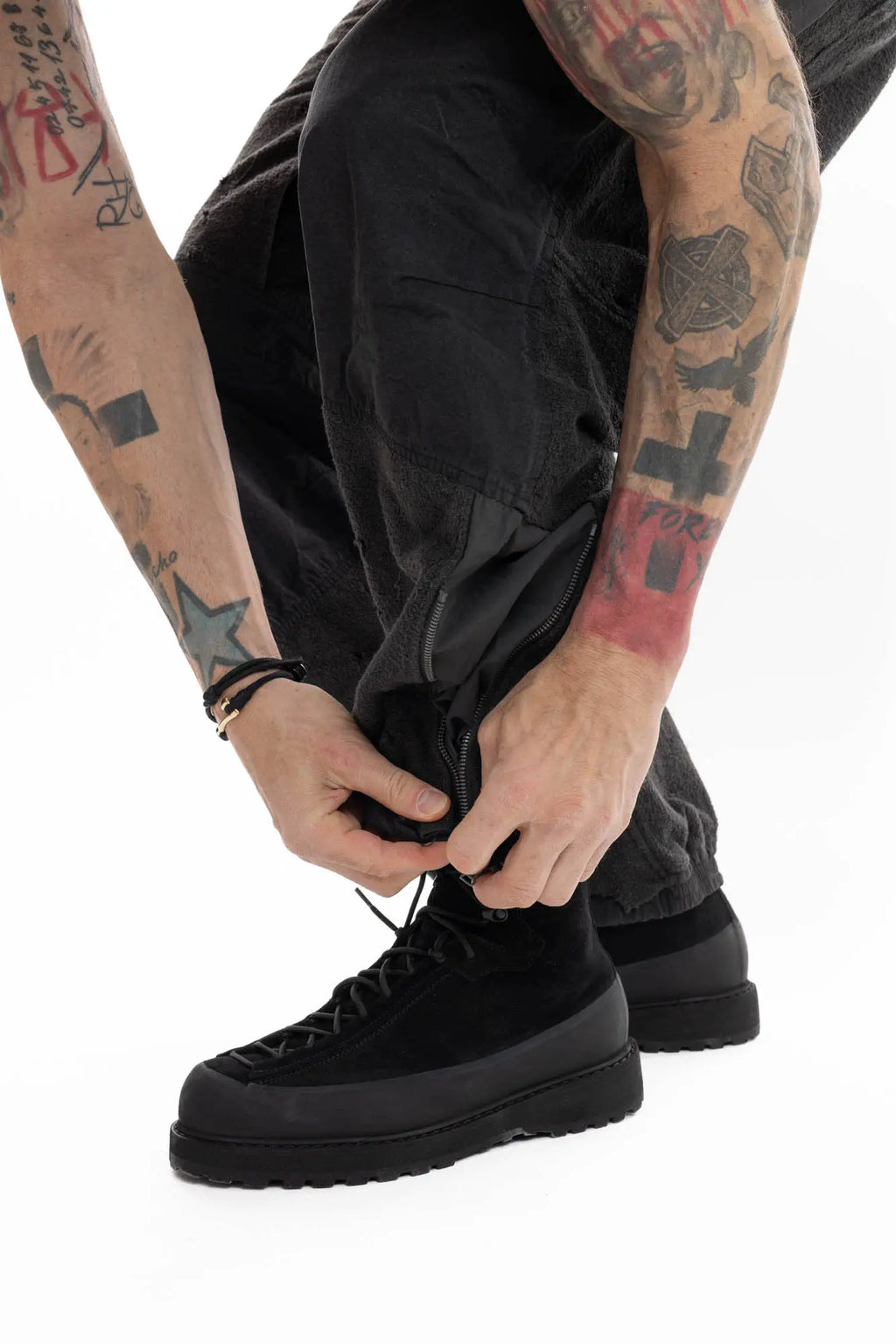 Hamcus, Mens Trousers, Black, Dark Grey, Straight Leg, Adjustable Cuffs, Side Pockets, Back Pockets, Belt Loops, Zip Fly, Multi Panel Construction, Leg Zips, Torn Design, Snap Closure, Drawcord Pockets, Vislon Zippers, Cuff Close-up. 