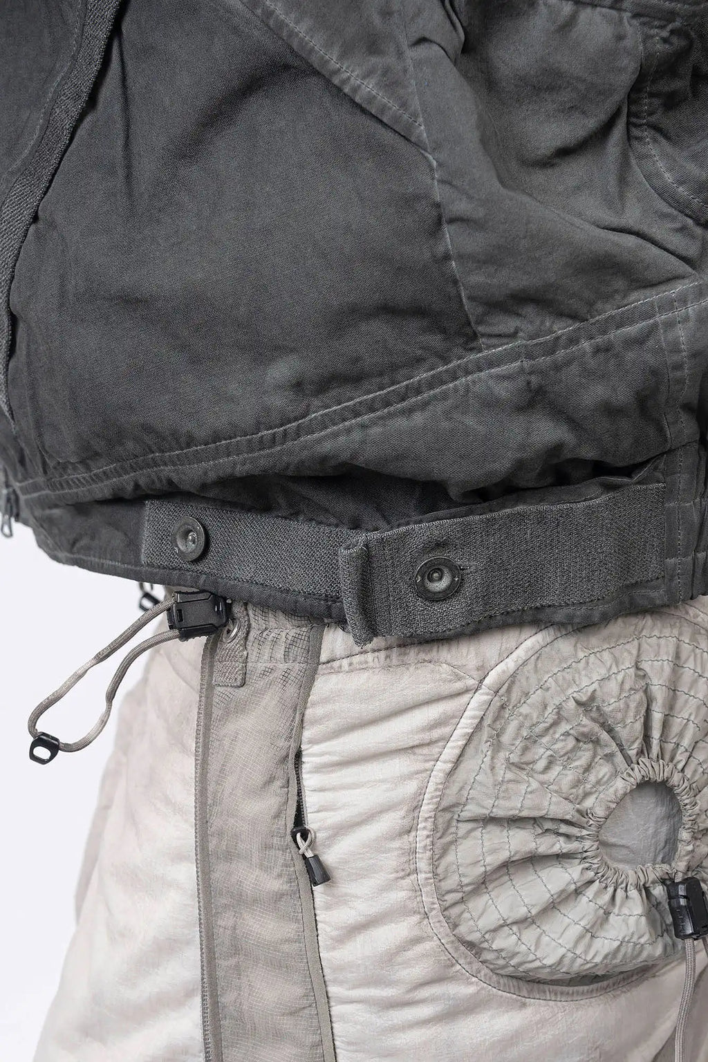 Hamcus, Mens Jacket, Fiend Grey, Dark Grey, Gray, Garment Dyed, Multiple Functional Pockets, Detachable Sleeves, Convertible Jacket, Full-Zip, Ventilation Eyelets, Zip Pockets, Centre Zip Closure, Detachable Lining Vest, Removable Vest Lining, 3-in-1 Garment, Convertible, Snap Adjustable Waist Close-up. 