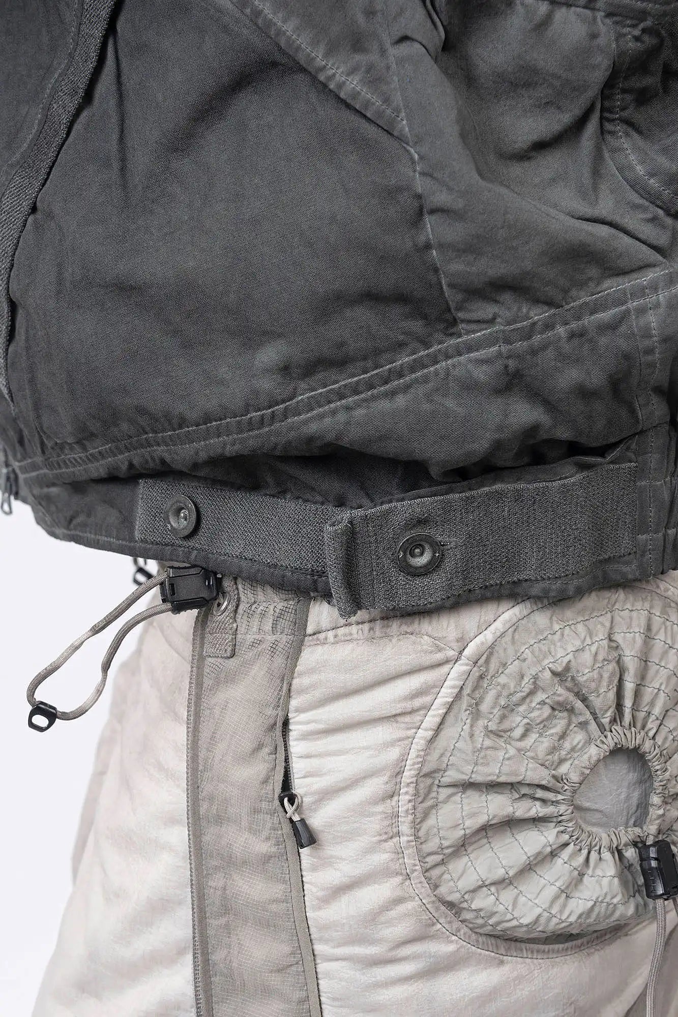 Hamcus, Mens Jacket, Fiend Grey, Dark Grey, Gray, Garment Dyed, Multiple Functional Pockets, Detachable Sleeves, Convertible Jacket, Full-Zip, Ventilation Eyelets, Zip Pockets, Centre Zip Closure, Detachable Lining Vest, Removable Vest Lining, 3-in-1 Garment, Convertible, Snap Adjustable Waist Close-up. 