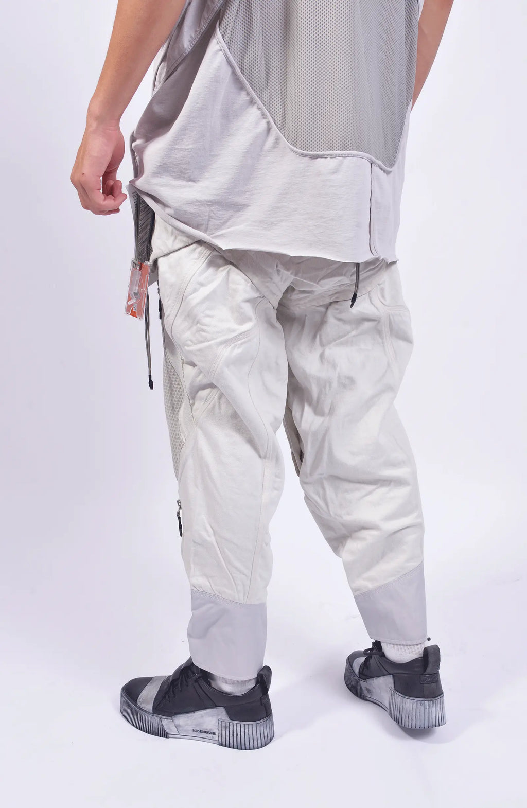 Hamcus, Mens Pants, White, Drawcord Pockets, Side Pockets, Leg Zippers, Adjustable Cuffs, Breathable Mesh, Breathable Legs, Back Pockets, Ventilation Zip Openings, Multi-Fabric Construction, Patchwork Design, Honeycomb Panels, Foam Modules, Back 3/4 View. 