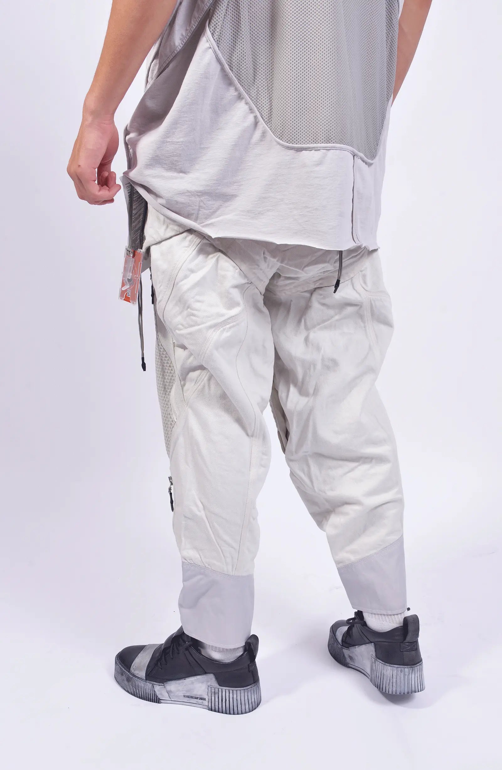 Hamcus, Mens Pants, White, Drawcord Pockets, Side Pockets, Leg Zippers, Adjustable Cuffs, Breathable Mesh, Breathable Legs, Back Pockets, Ventilation Zip Openings, Multi-Fabric Construction, Patchwork Design, Honeycomb Panels, Foam Modules, Back 3/4 View. 