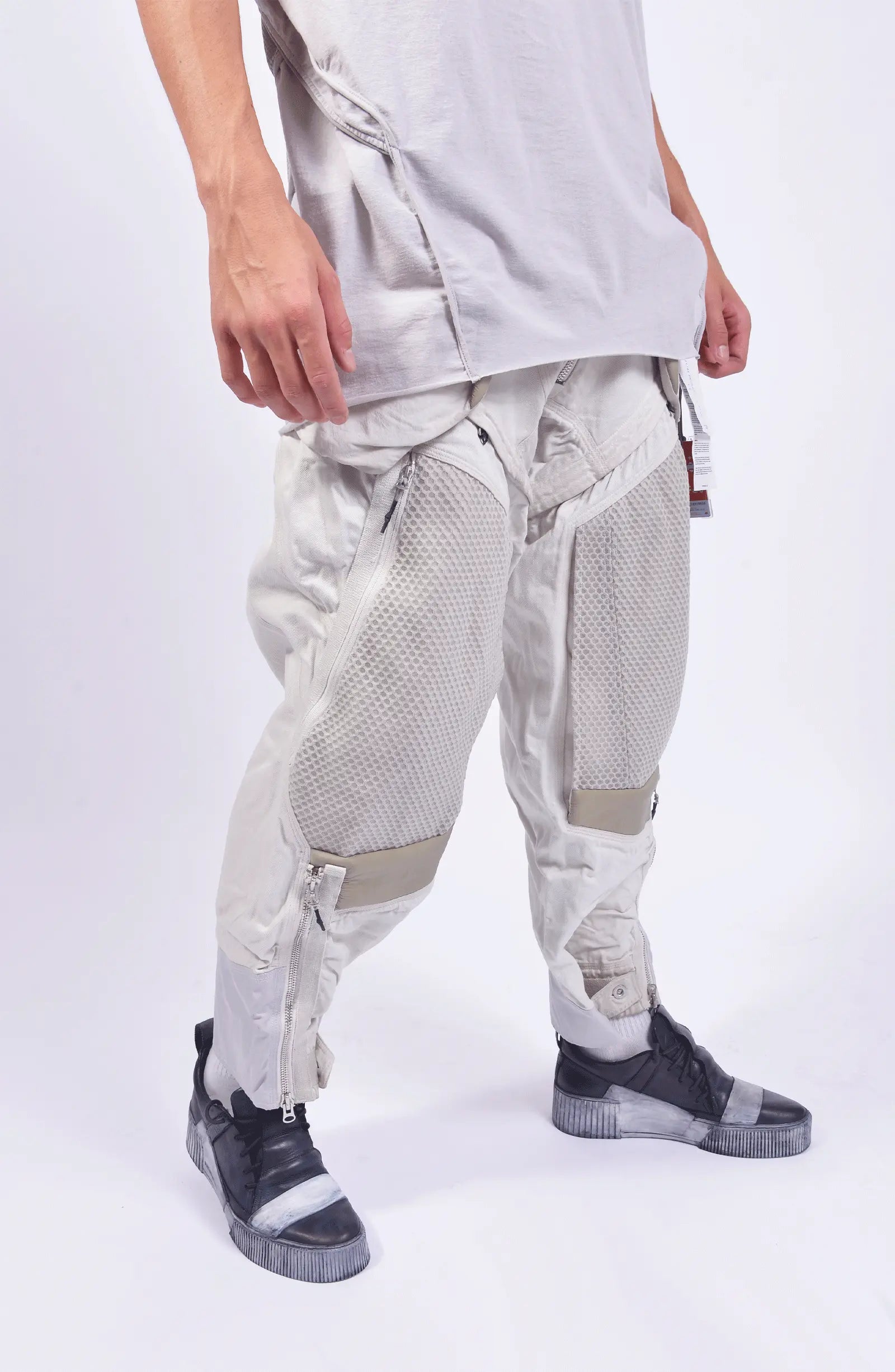 Hamcus, Mens Pants, White, Drawcord Pockets, Side Pockets, Leg Zippers, Adjustable Cuffs, Breathable Mesh, Breathable Legs, Back Pockets, Ventilation Zip Openings, Multi-Fabric Construction, Patchwork Design, Honeycomb Panels, Foam Modules, Front Portrait 3/4 View. 