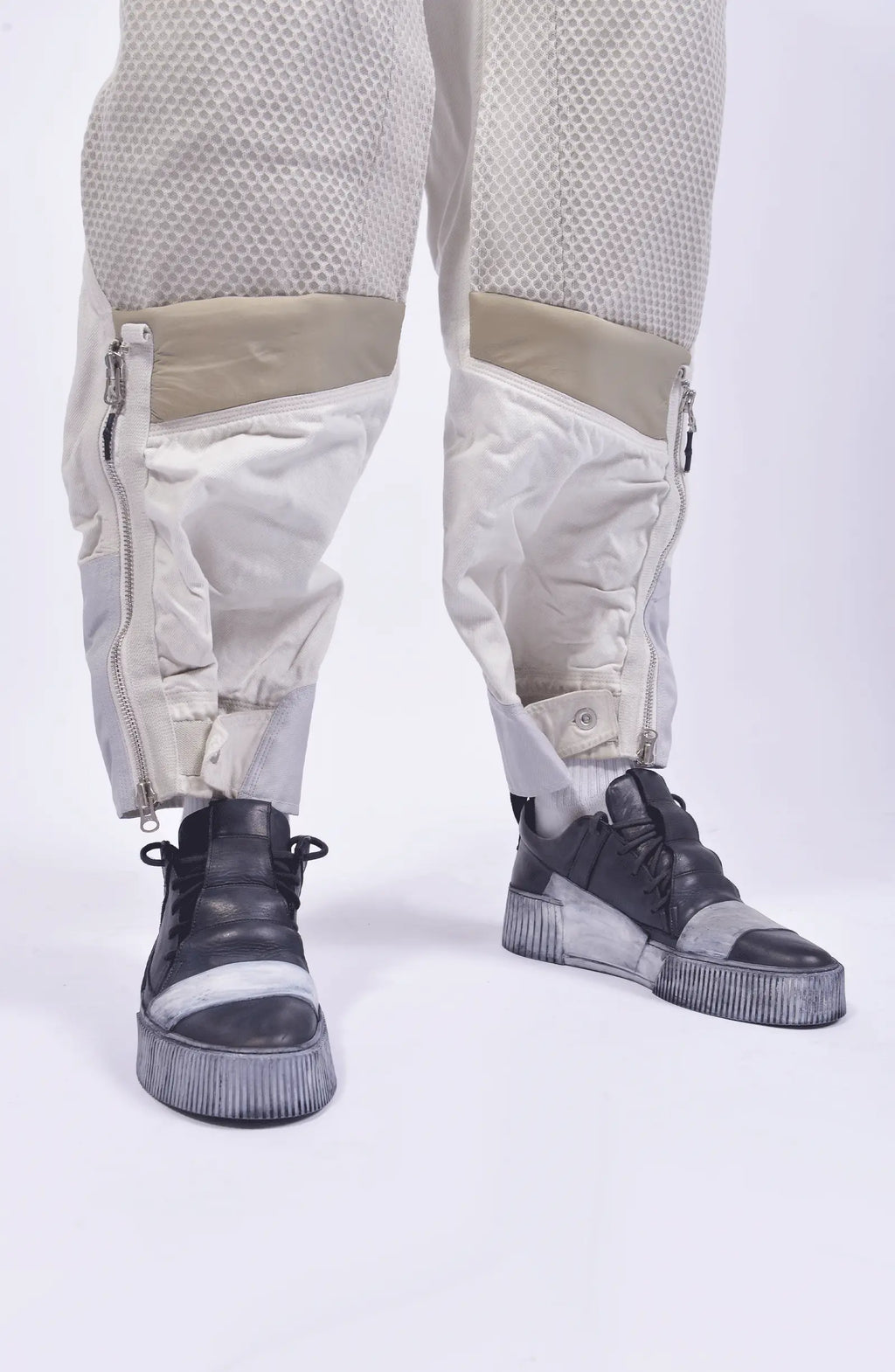 Hamcus, Mens Pants, White, Drawcord Pockets, Side Pockets, Leg Zippers, Adjustable Cuffs, Breathable Mesh, Breathable Legs, Back Pockets, Ventilation Zip Openings, Multi-Fabric Construction, Patchwork Design, Honeycomb Panels, Foam Modules, Leg Adjusters Close-up. 