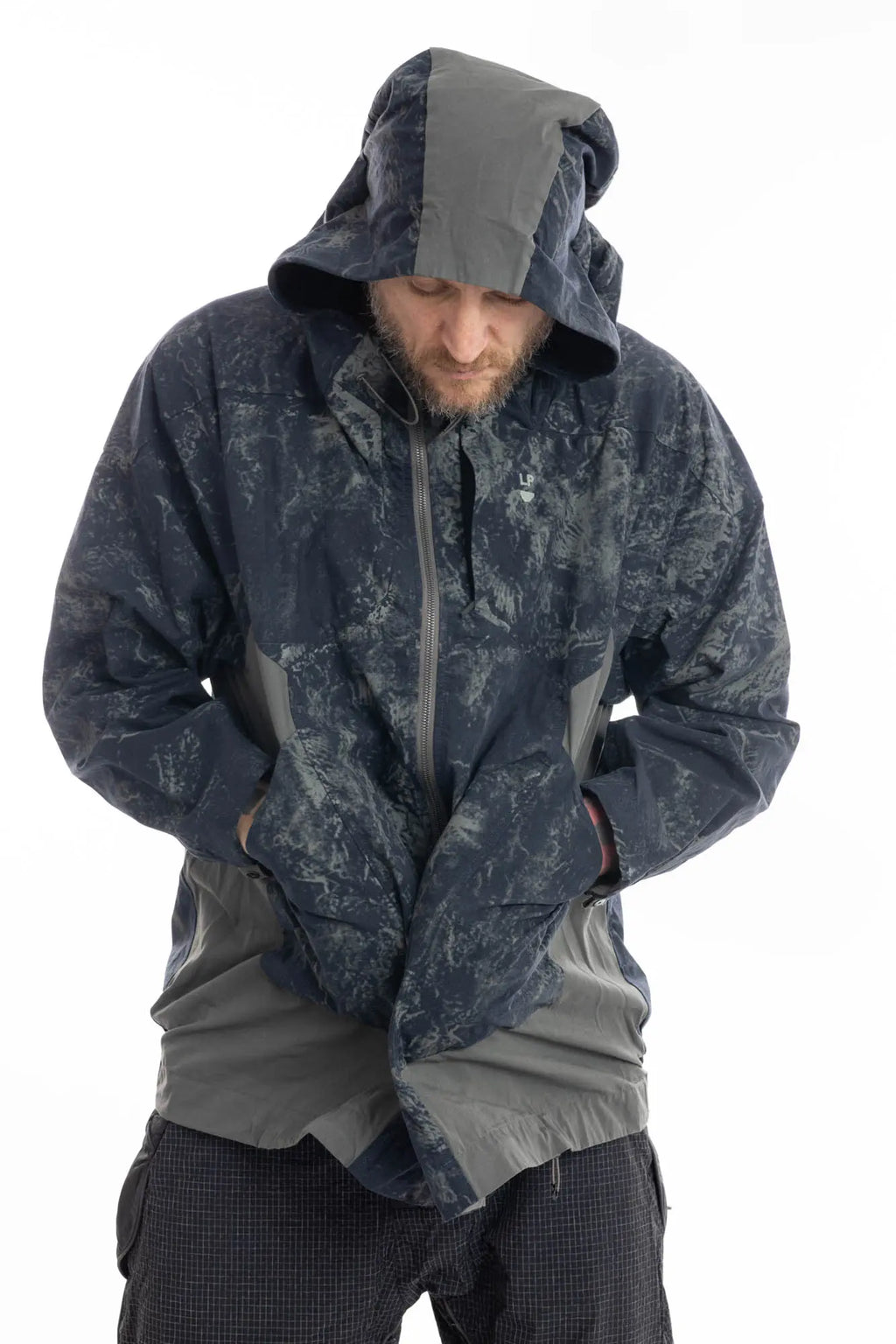 Hamcus, Mens Jacket, Geomapping Scan Print, Blue, Gray, Black, Hooded, Drawcord Hood, Side Pockets, Full Zip, Chest Logo, Waterproof, Grey Panel Inserts, Cotton, Polyamide, Elastic Cuffs and Hem, Adjustable Hem, Zip Pockets, Front Portrait Hooded Hands in Pockets Leaning Forward. 