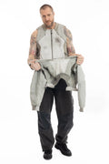 Hamcus, Mens Jacket, Beige, Light Grey, Light Brown, Full Zip, Removable Sleeves, Dual Module Jacket, Side Zip Pockets, Quilted with Thermolite, DWR Coated, Insulated, Ribbed Neck and Cuffs, Panel Construction, Removable Lining, Full Body Front View Holding Sleeves. 