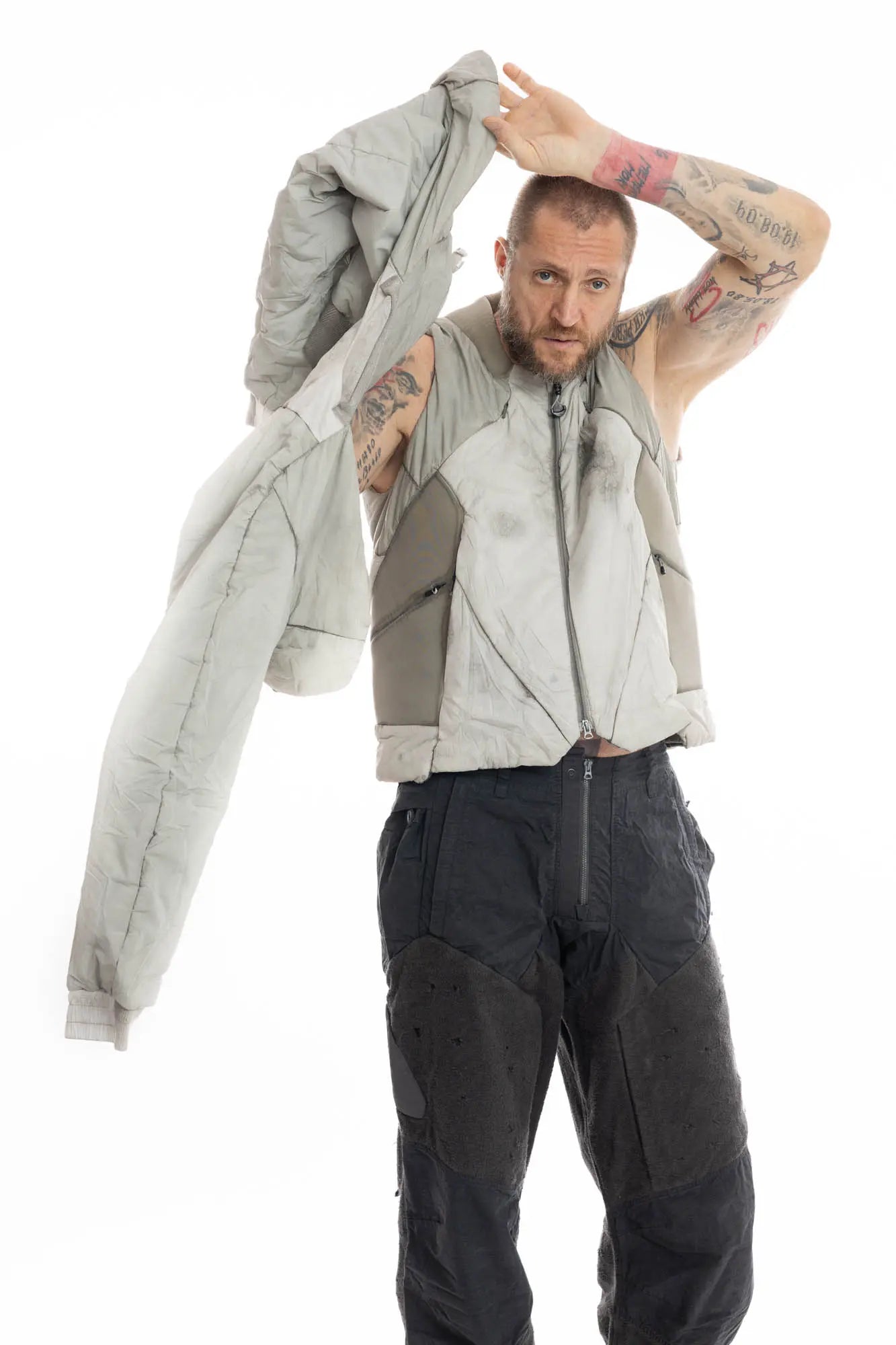 Hamcus, Mens Jacket, Beige, Light Grey, Light Brown, Full Zip, Removable Sleeves, Dual Module Jacket, Side Zip Pockets, Quilted with Thermolite, DWR Coated, Insulated, Ribbed Neck and Cuffs, Panel Construction, Removable Lining, Putting on Second Module Front View. 