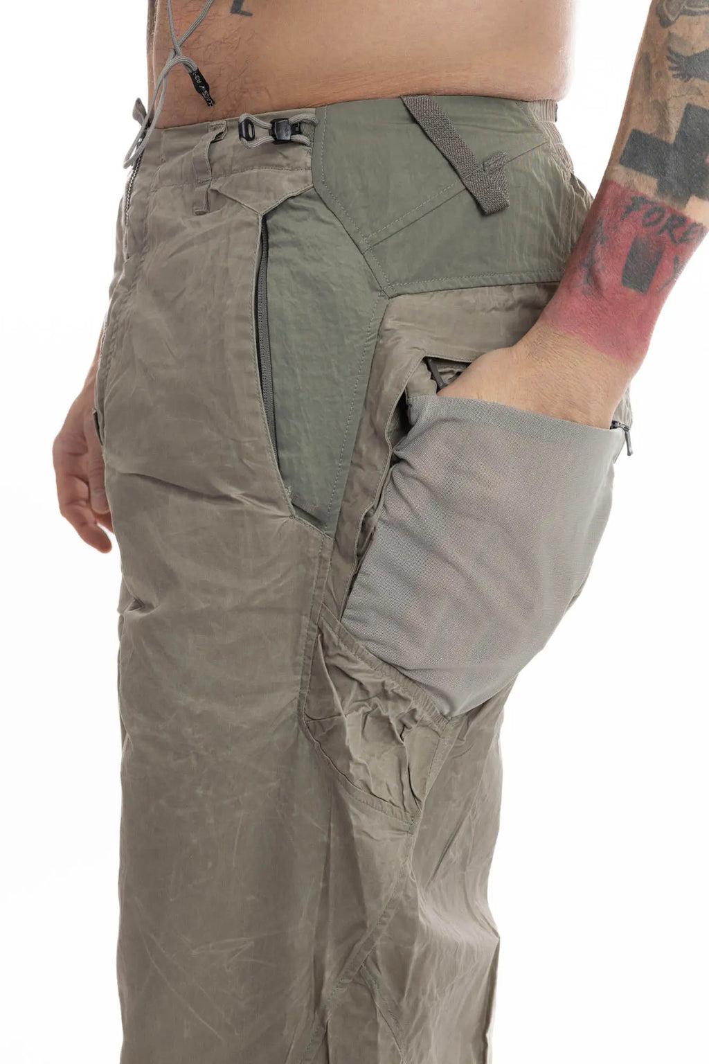 Hamcus, Mens Trousers, Olive, Beige, Light Brown, Smeared, Side Zips, Side ZIppers, Adjustable Cuffs, Elastic Drawcord Waistband, Belt Loops, Zip-Fly, Back Pockets, Polyester, Polyamide, Translucent, Transparent, Straight Leg, Wide-fit, Back Pocket Side View Showcase. 