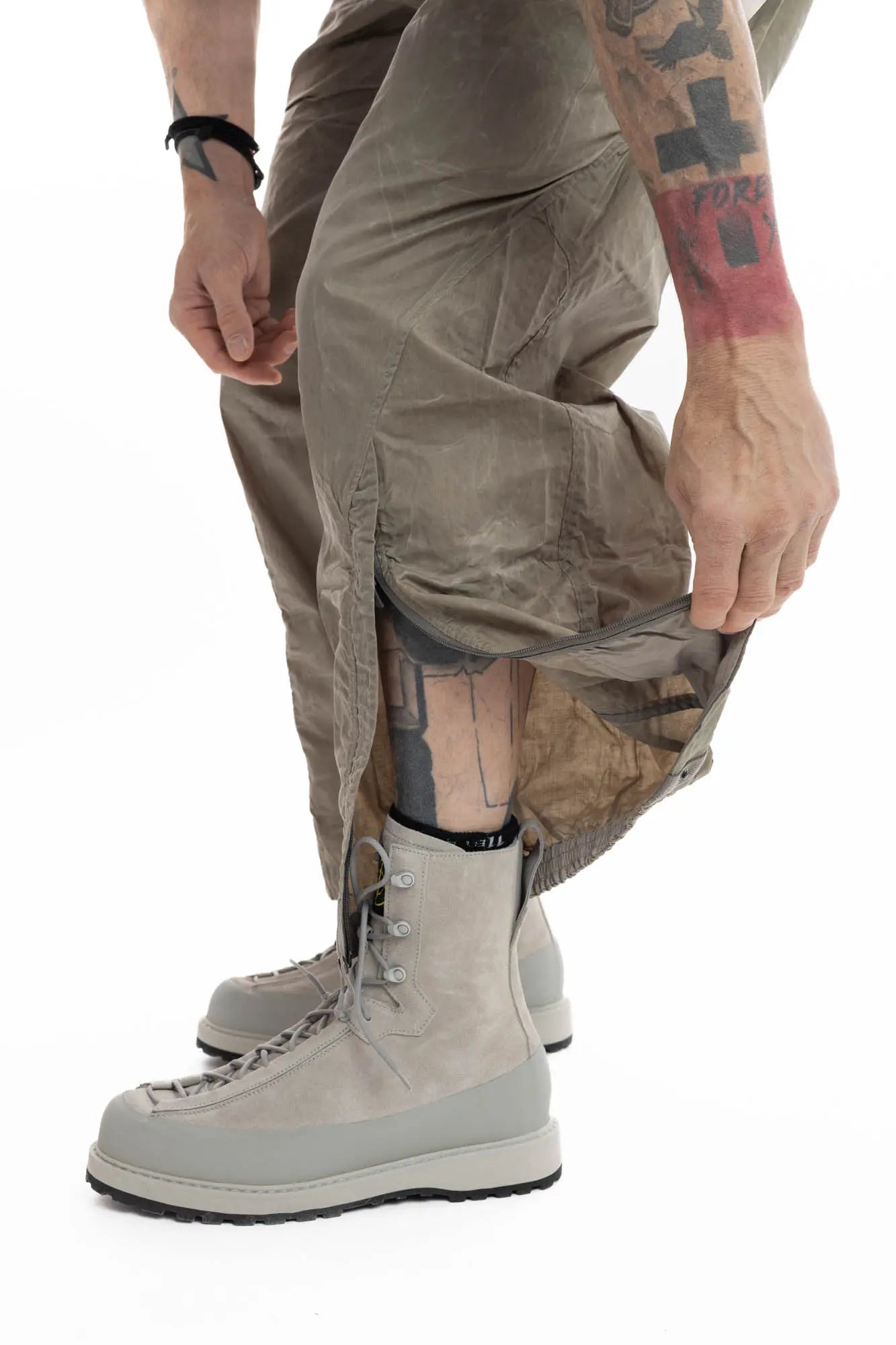 Hamcus, Mens Trousers, Olive, Beige, Light Brown, Smeared, Side Zips, Side ZIppers, Adjustable Cuffs, Elastic Drawcord Waistband, Belt Loops, Zip-Fly, Back Pockets, Polyester, Polyamide, Translucent, Transparent, Straight Leg, Wide-fit, Unzipped Leg Showcase. 