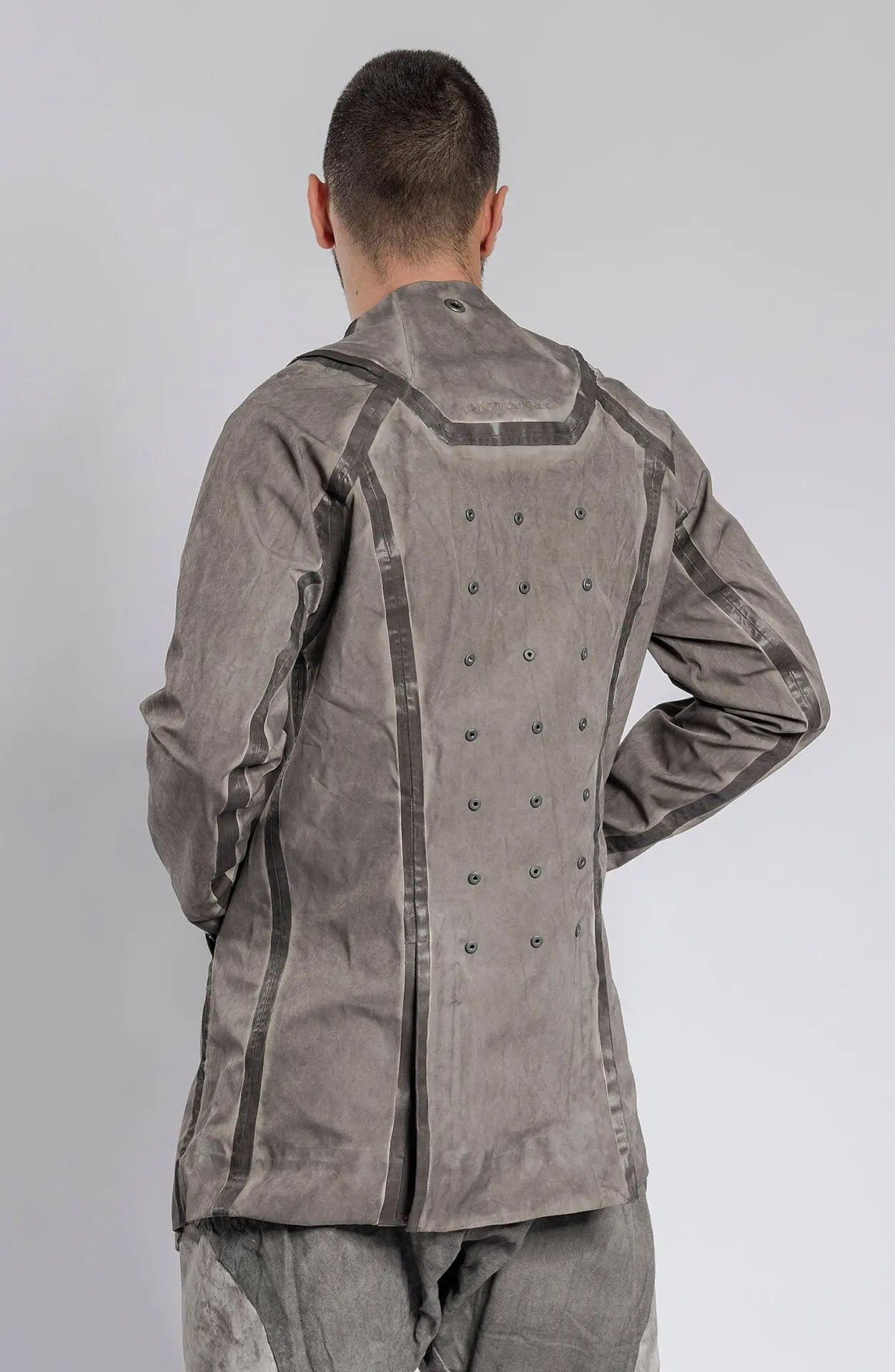 Hamcus, Mens Blazer, Stealth Grey, Metal Gear Solid, Metal Eyelets, Taped Seams, Magnetic Snap Closure, Ventilation Openings, Double Sleeves, Adjustable Cuffs, Long Sleeves, Breathable, Back 3/4 View. 