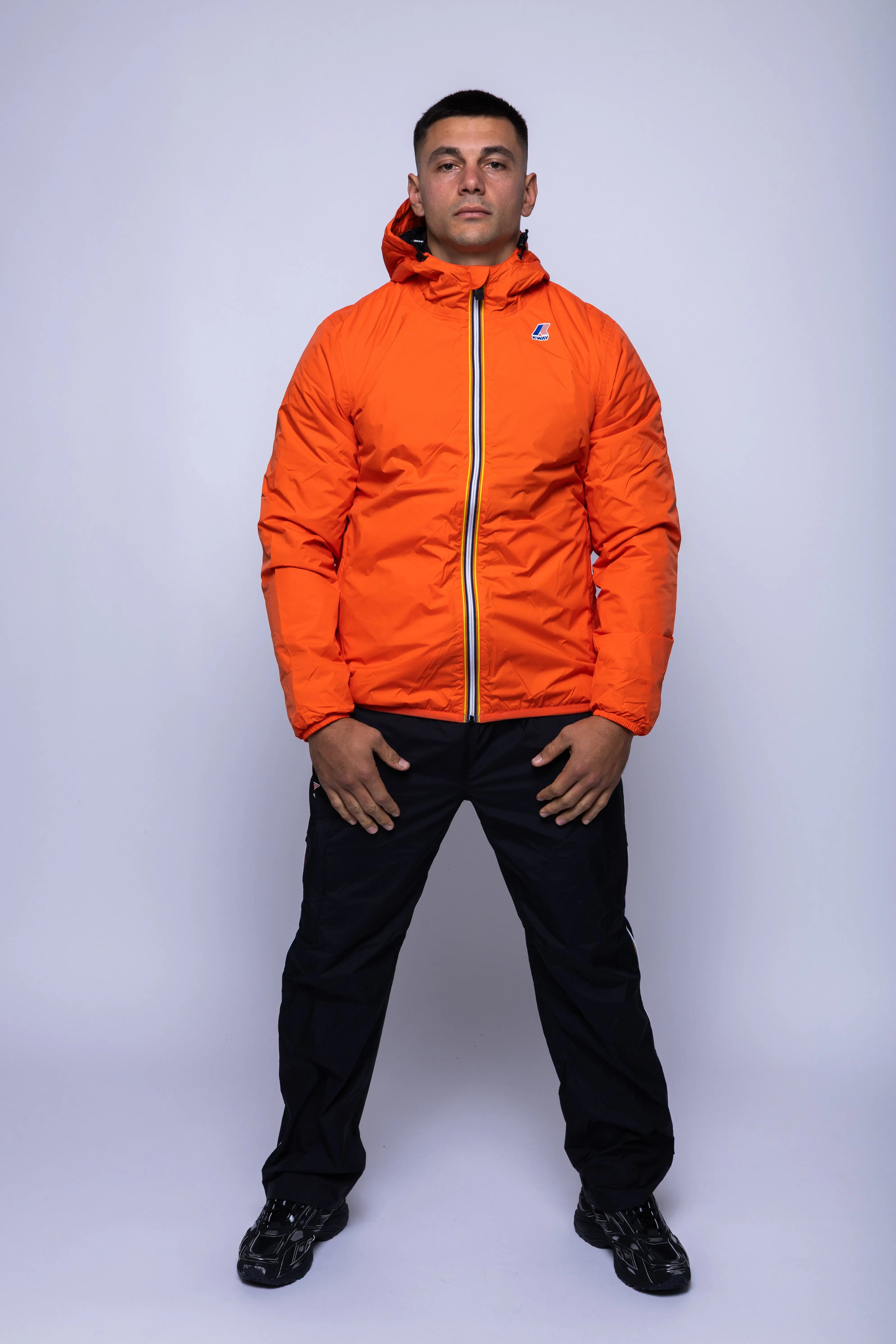 K-Way, Mens Jacket, Orange Fiesta, Full-Zip, Hooded, Side Pockets, Branded Zippers, Packable, Unisex, Long Sleeves, Waterproof 10000 mm water column, Windproof, Breathable, Water-Repellent, Elasticated Cuffs and Hem, Breathability: 10000 g/sqm/24h, Full Body Front View. 